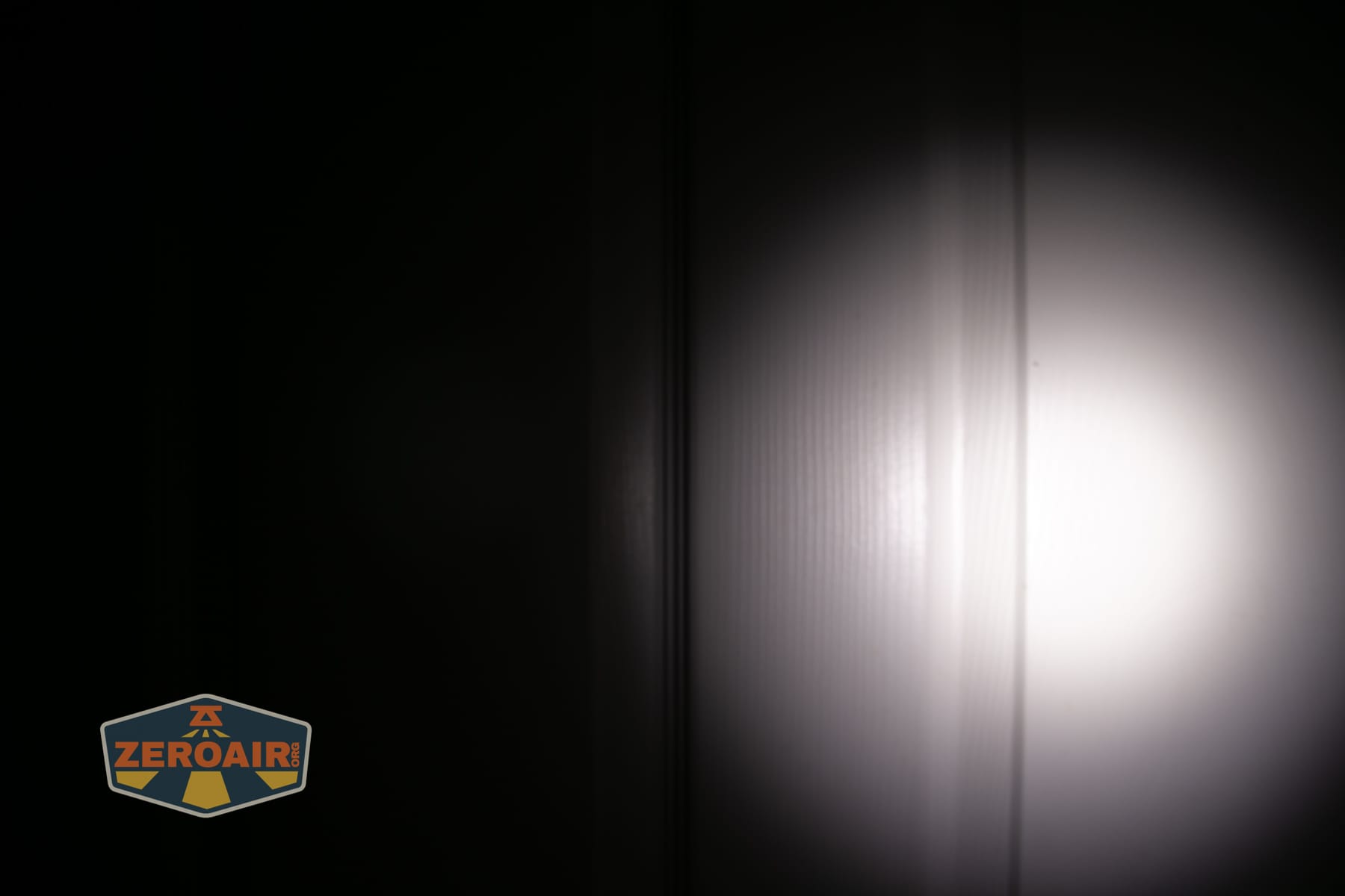 Olight Baton Ultra OAL flashlight beamshots on door (at 1') compared to nichia 219b 4500K