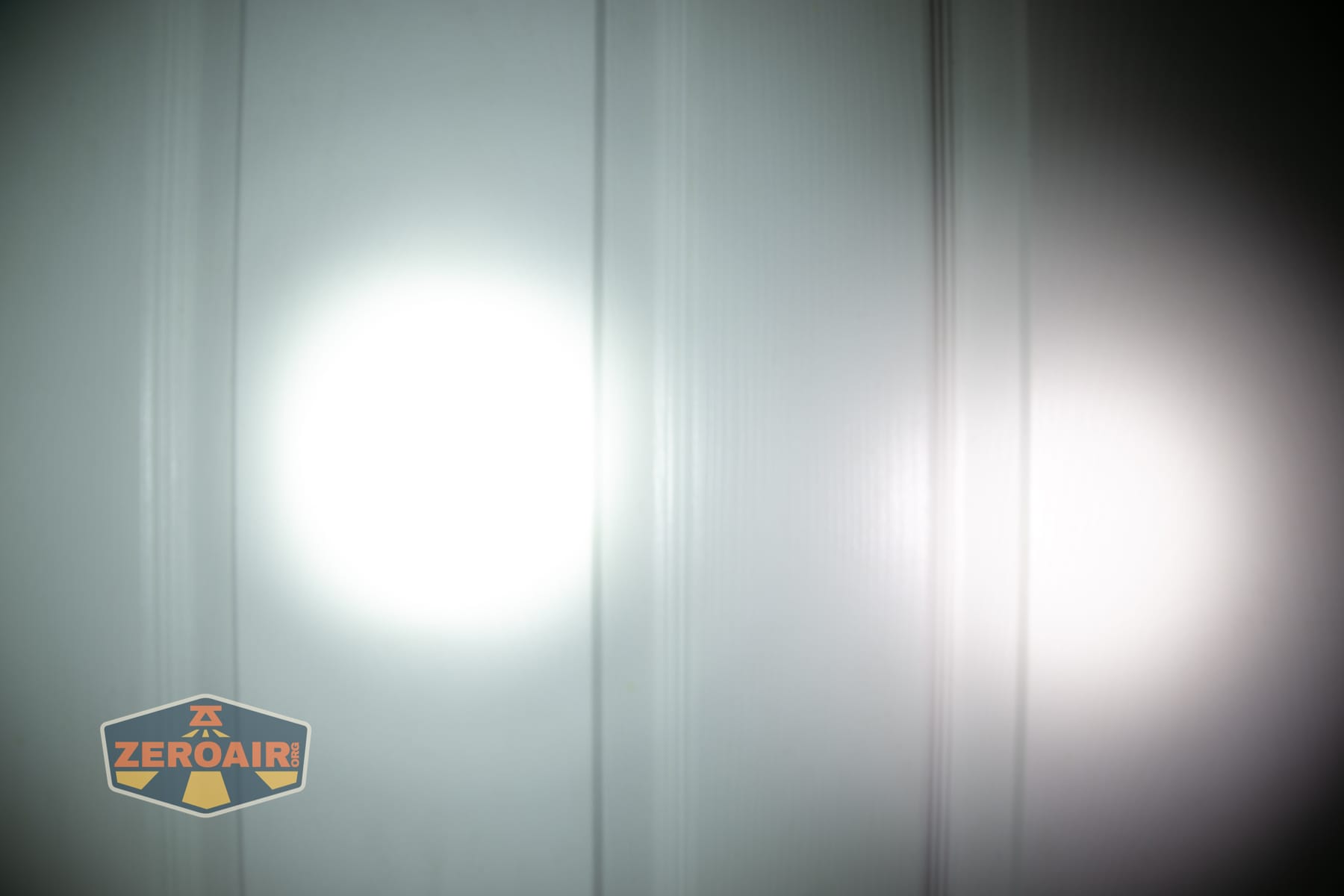 Olight Baton Ultra OAL flashlight beamshots on door (at 1') compared to nichia 219b 4500K