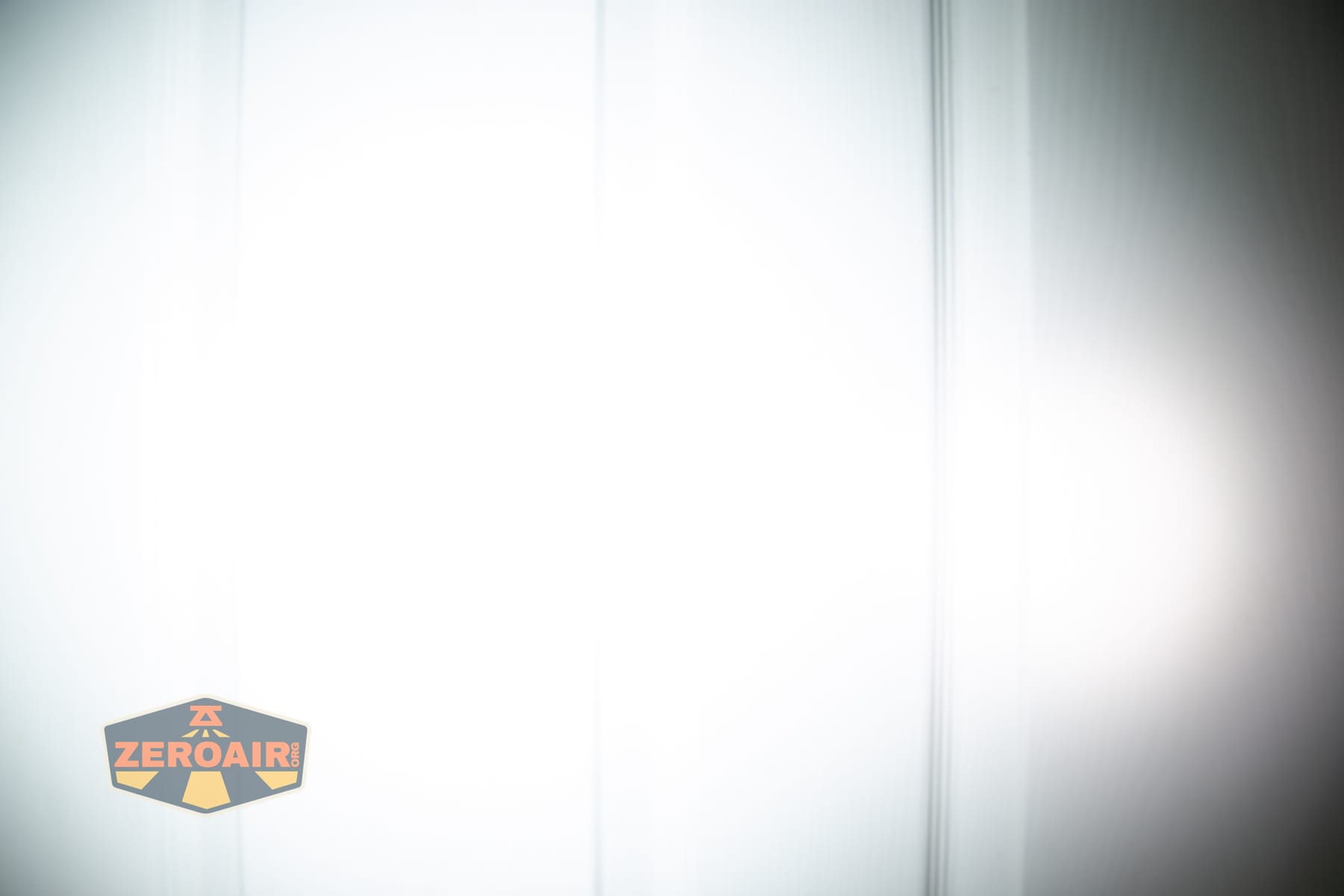 Olight Baton Ultra OAL flashlight beamshots on door (at 1') compared to nichia 219b 4500K