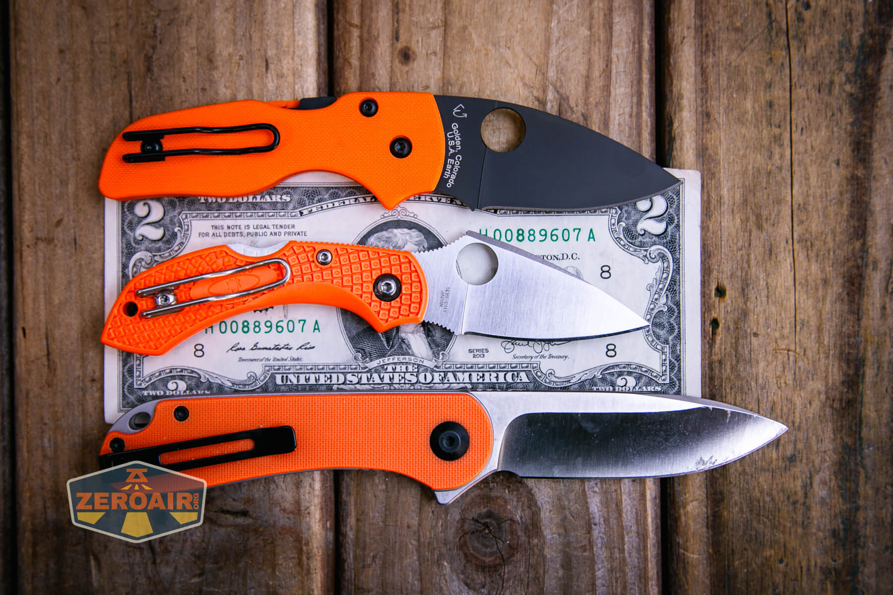 Spyderco Dragonfly 2 Lightweight knife on a two dollar bill compared to Civivi Elementum in orange