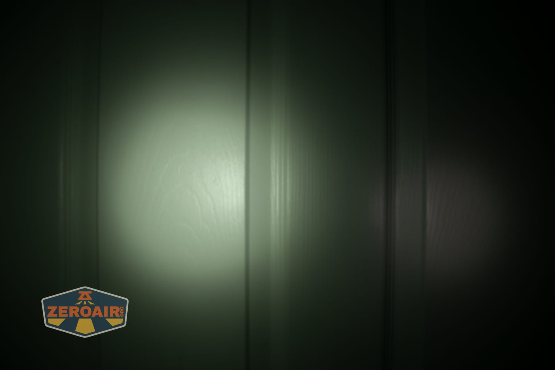 Trustfire Mini C Multifunctional clip-on flashlight beamshots on door (at 1') compared to nichia 219b 4500K