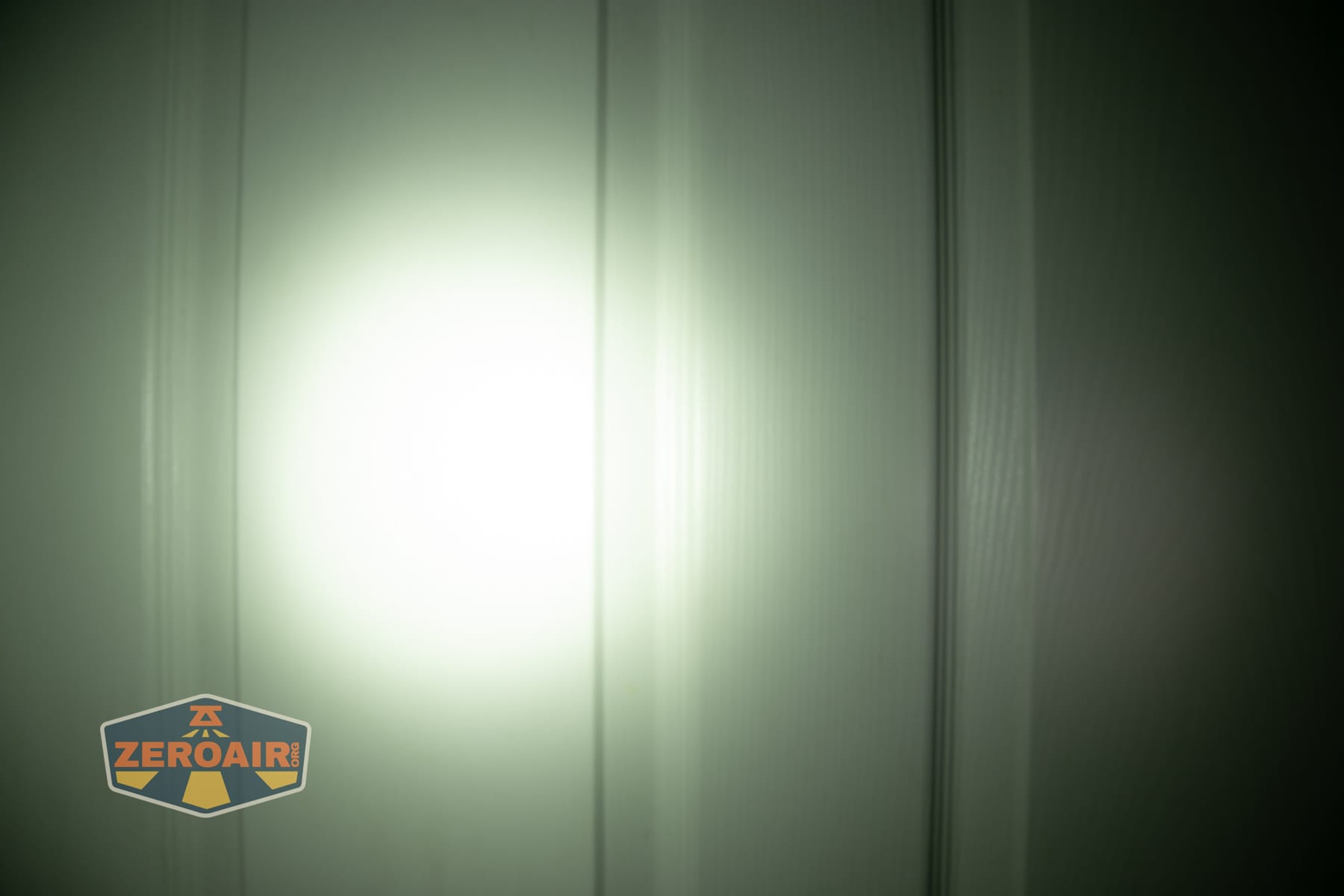 Trustfire Mini C Multifunctional clip-on flashlight beamshots on door (at 1') compared to nichia 219b 4500K