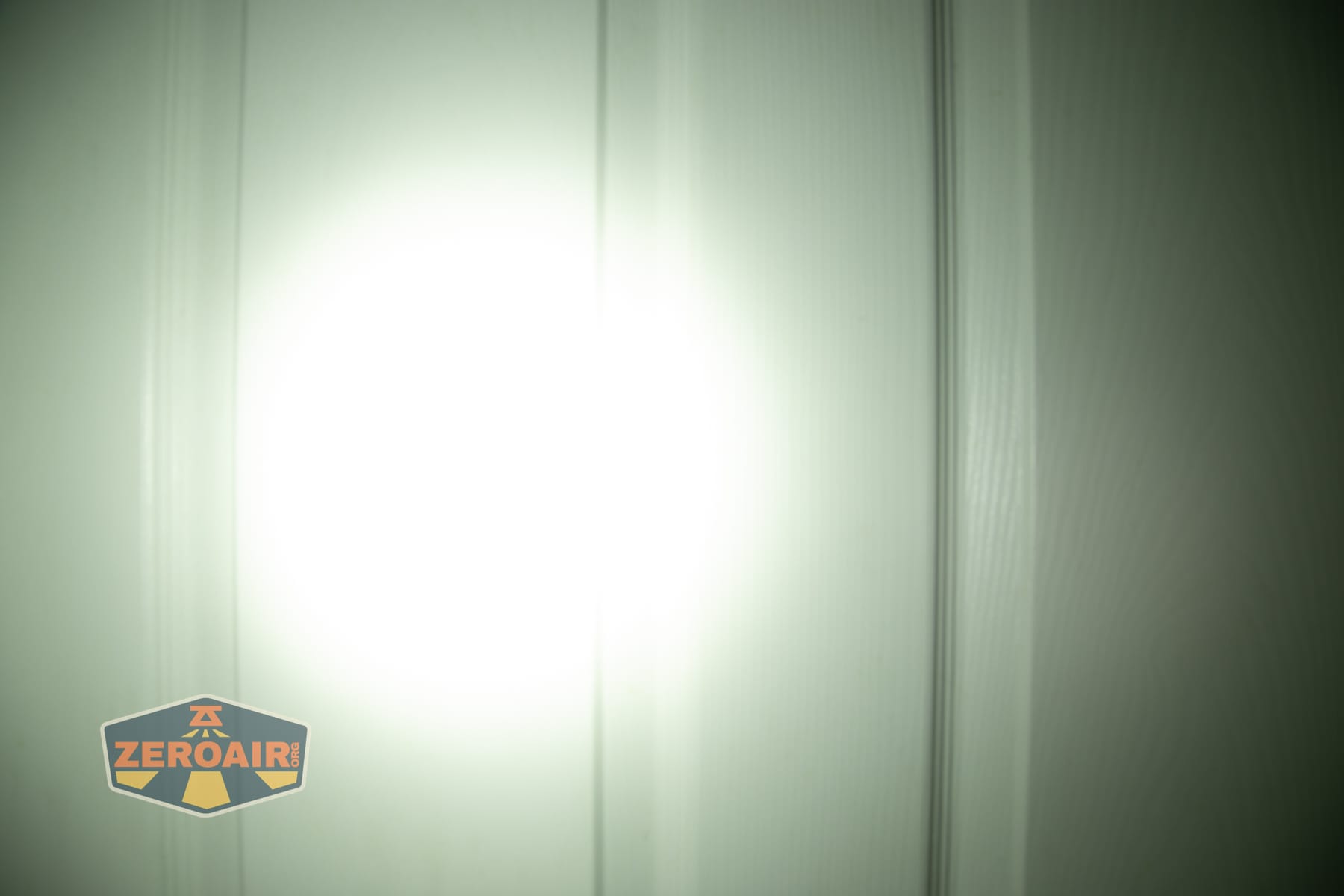 Trustfire Mini C Multifunctional clip-on flashlight beamshots on door (at 1') compared to nichia 219b 4500K