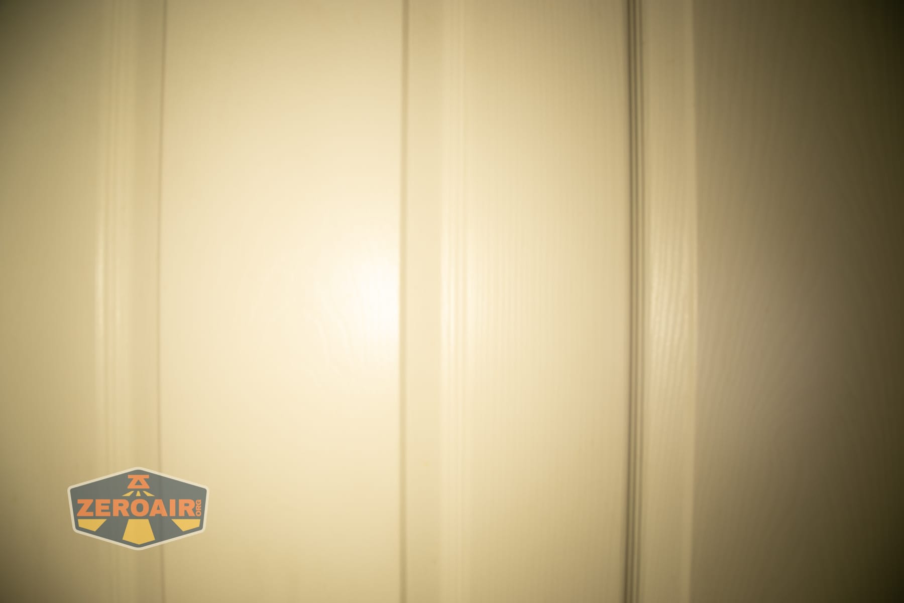 Trustfire Mini C Multifunctional clip-on flashlight beamshots on door (at 1') compared to nichia 219b 4500K