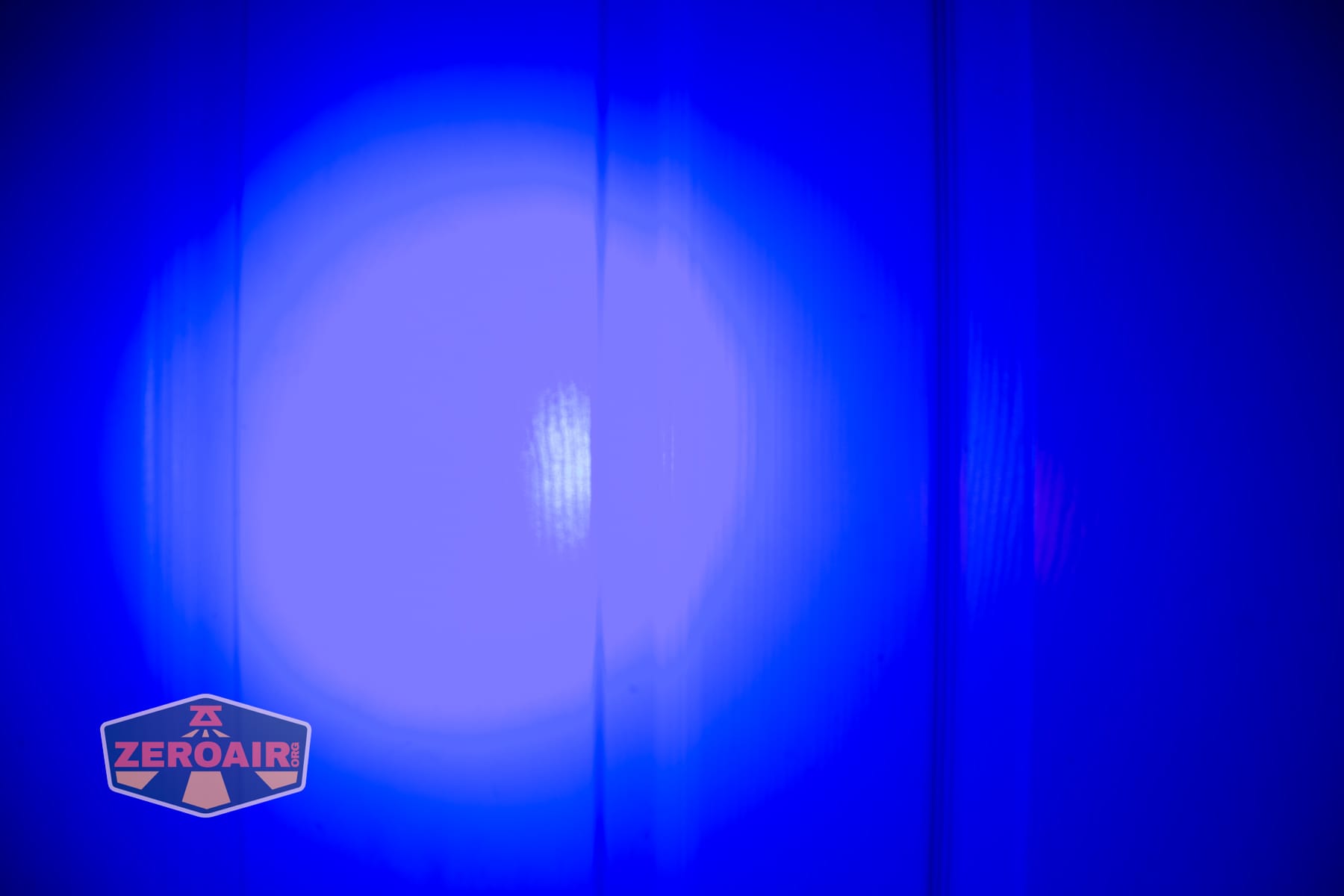 Trustfire Mini C Multifunctional clip-on flashlight beamshots on door (at 1') compared to nichia 219b 4500K