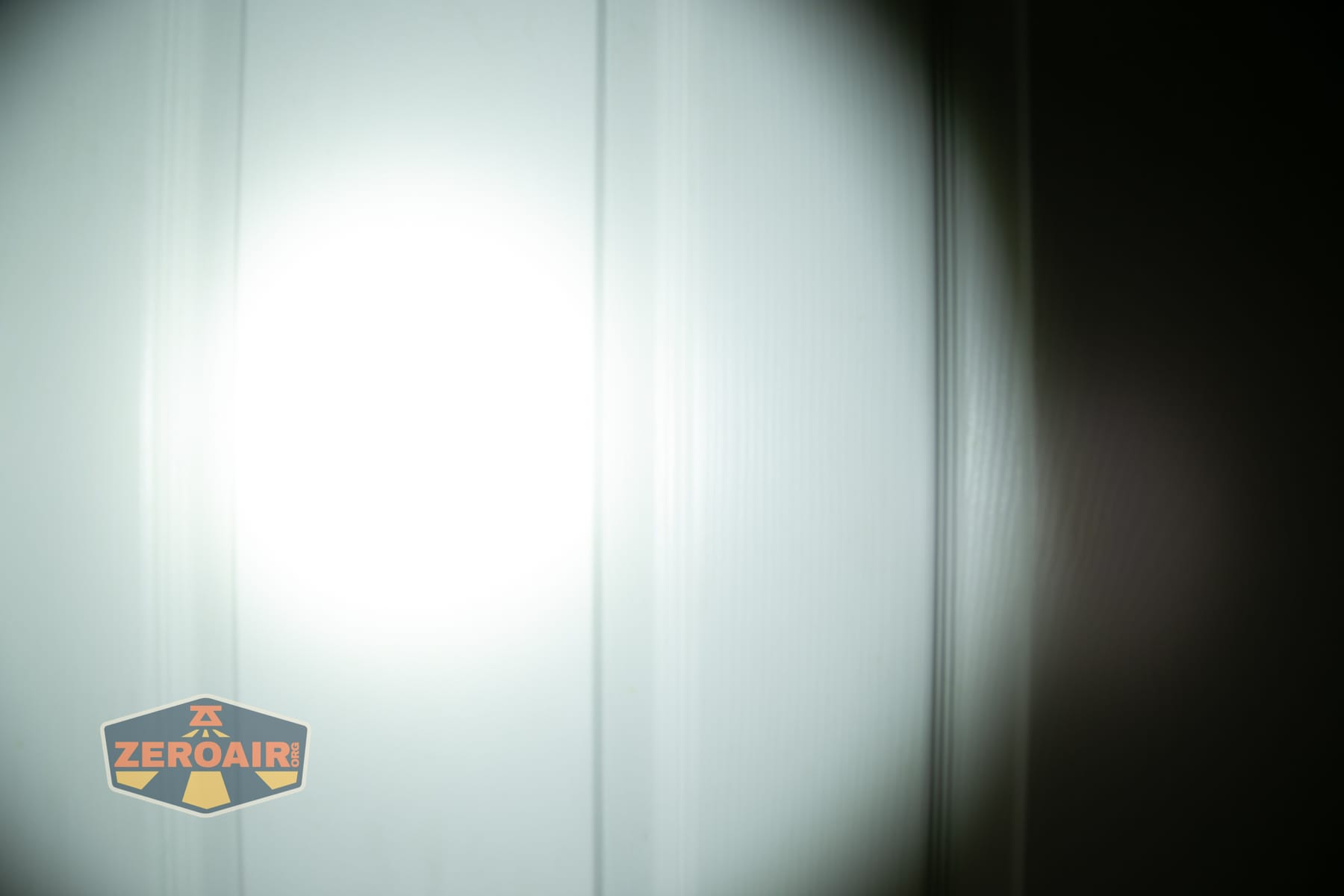 Wuben X1 Pro 2 flashlight beamshots on door (at 1') compared to nichia 219b 4500K