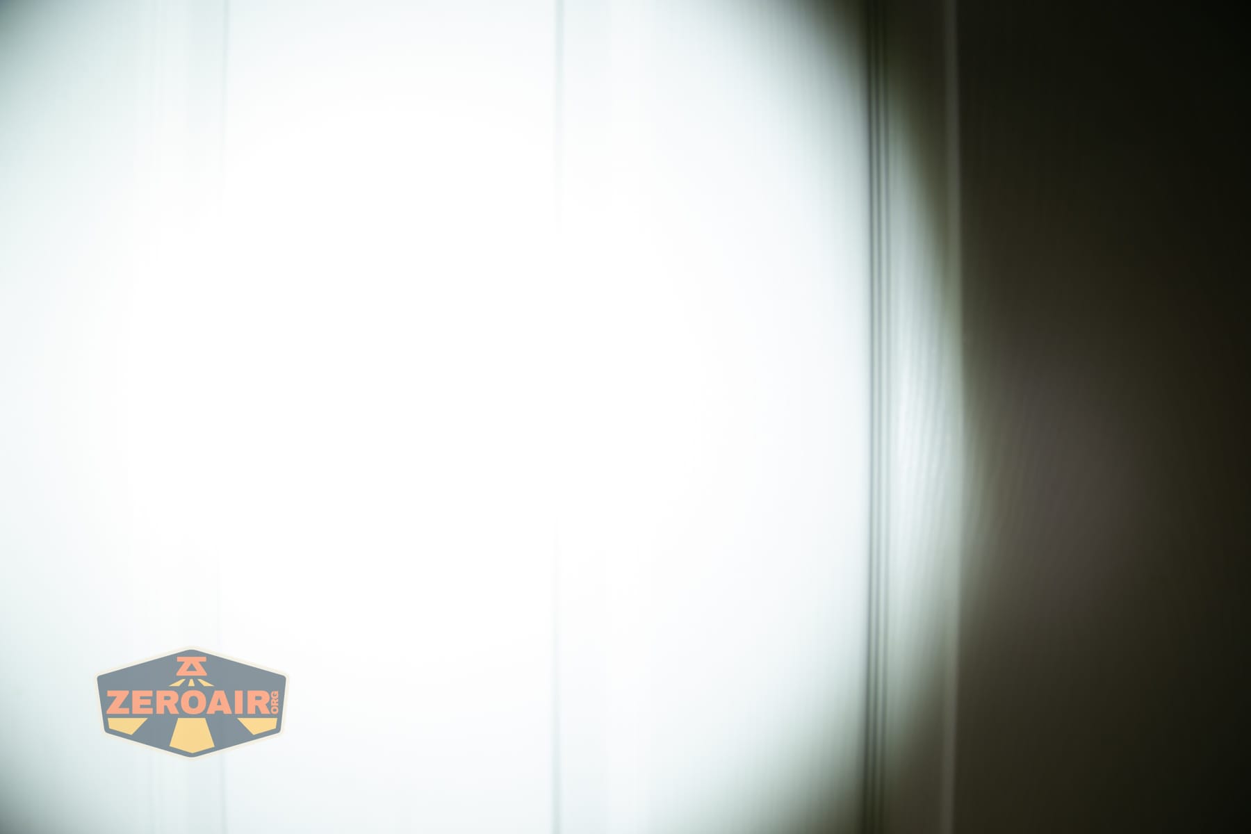 Wuben X1 Pro 2 flashlight beamshots on door (at 1') compared to nichia 219b 4500K