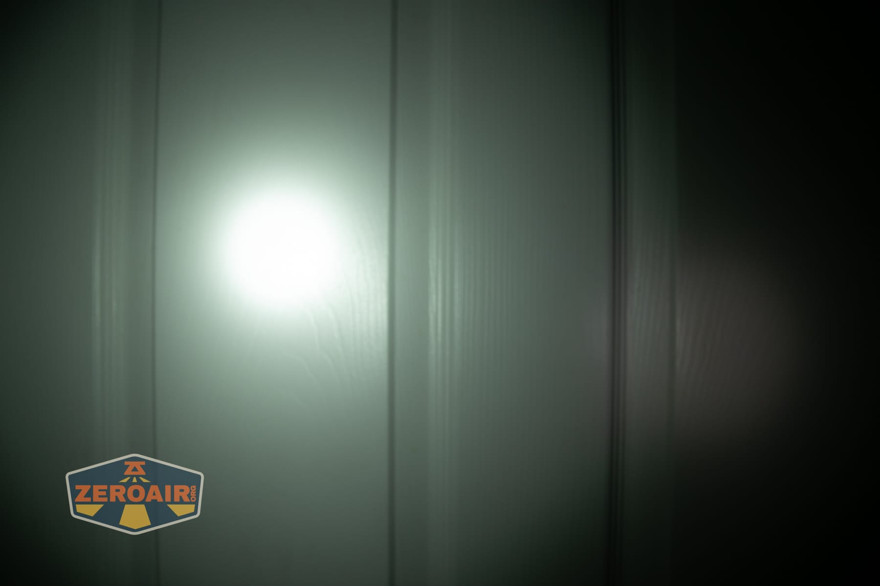Wuben X1 Pro 2 flashlight beamshots on door (at 1') compared to nichia 219b 4500K