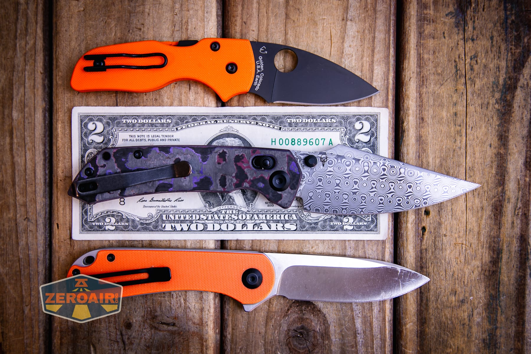 Kansept Fenrir Fatcarbon knife on a two dollar bill compared to Civivi Elementum in orange