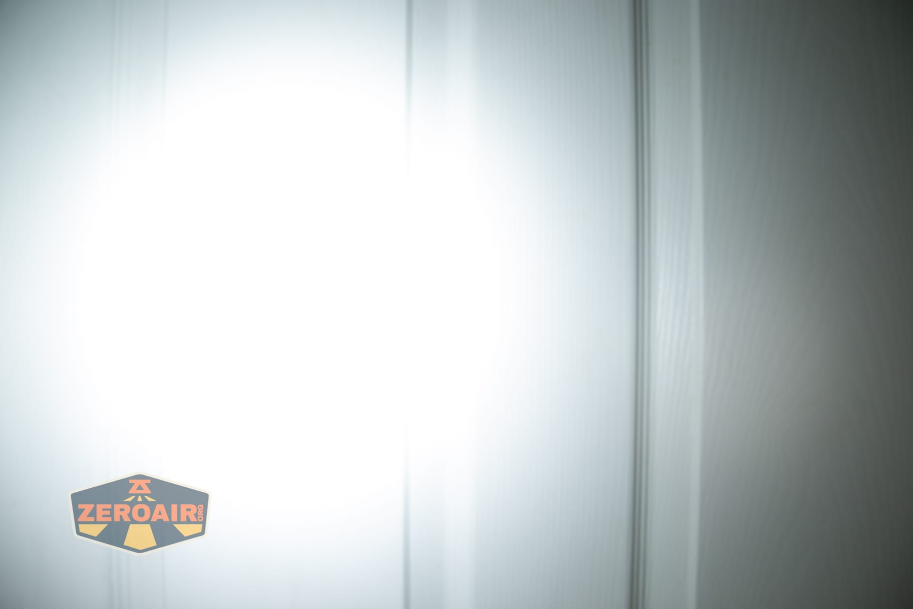 Nextorch eStar headlamp beamshots on door (at 1') compared to nichia 219b 4500K