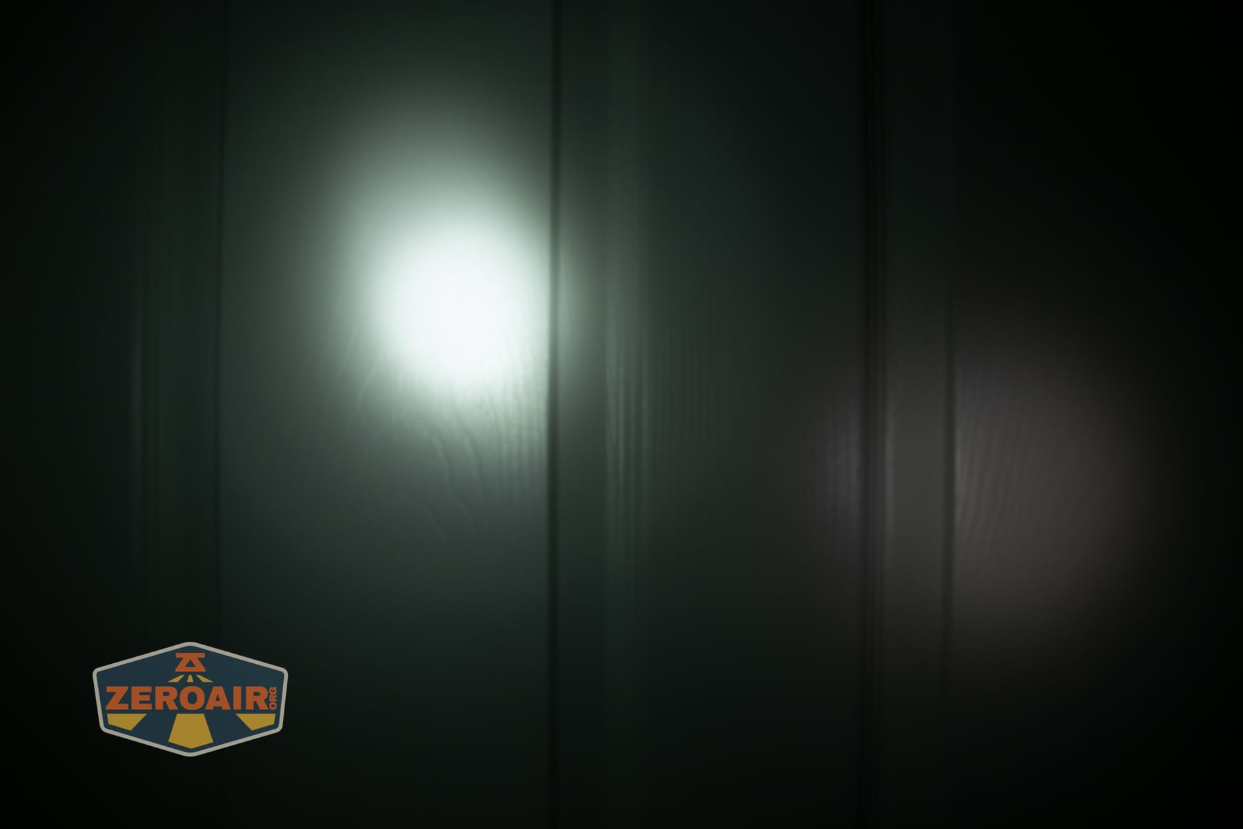 Nextorch eStar headlamp beamshots on door (at 1') compared to nichia 219b 4500K