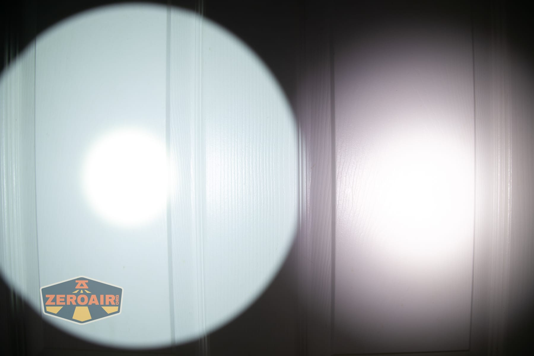 SPERAS T217 V3 Long Range Hunting flashlight beamshots on door compared to nichia 219b