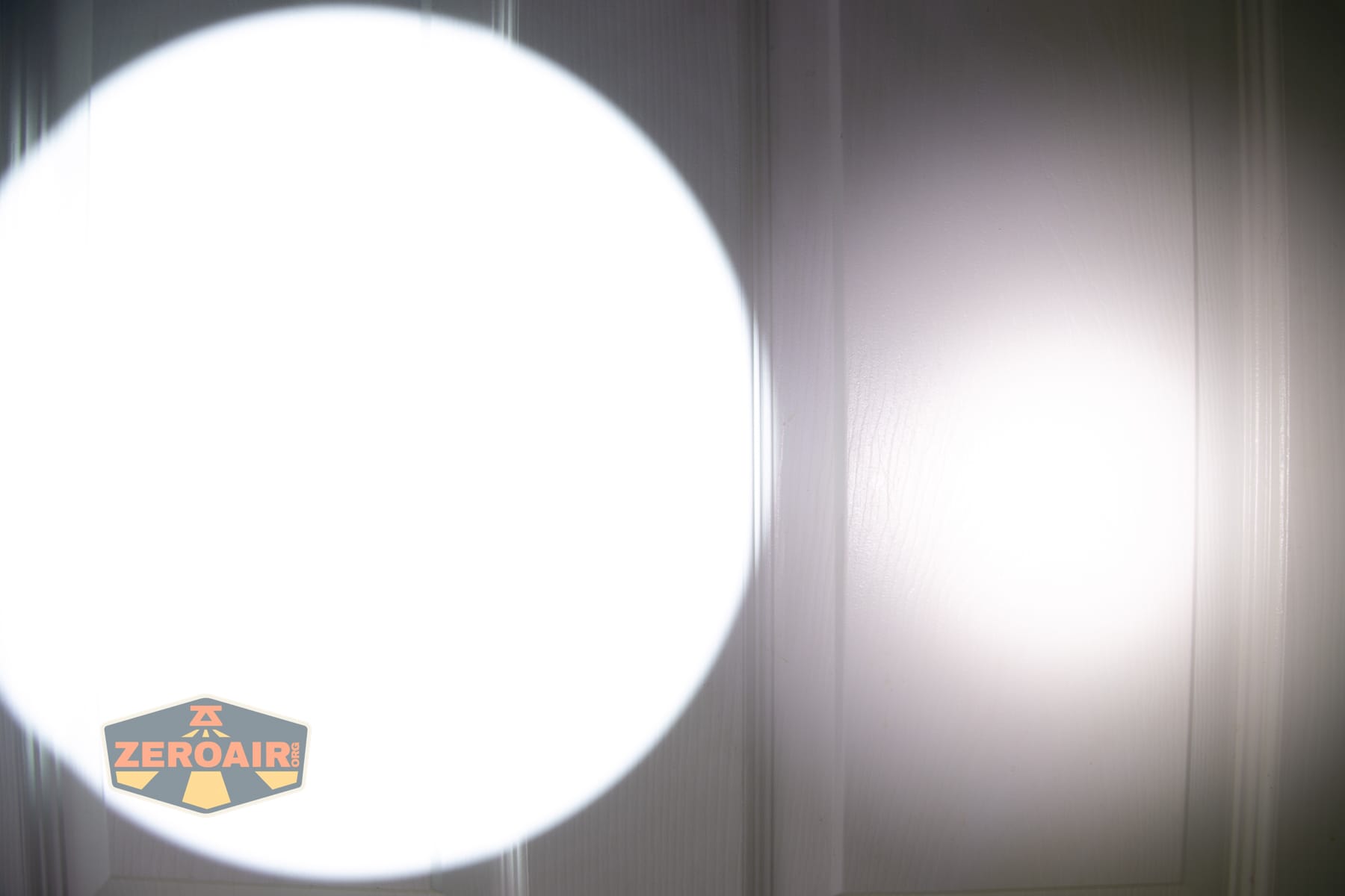 SPERAS T217 V3 Long Range Hunting flashlight beamshots on door compared to nichia 219b