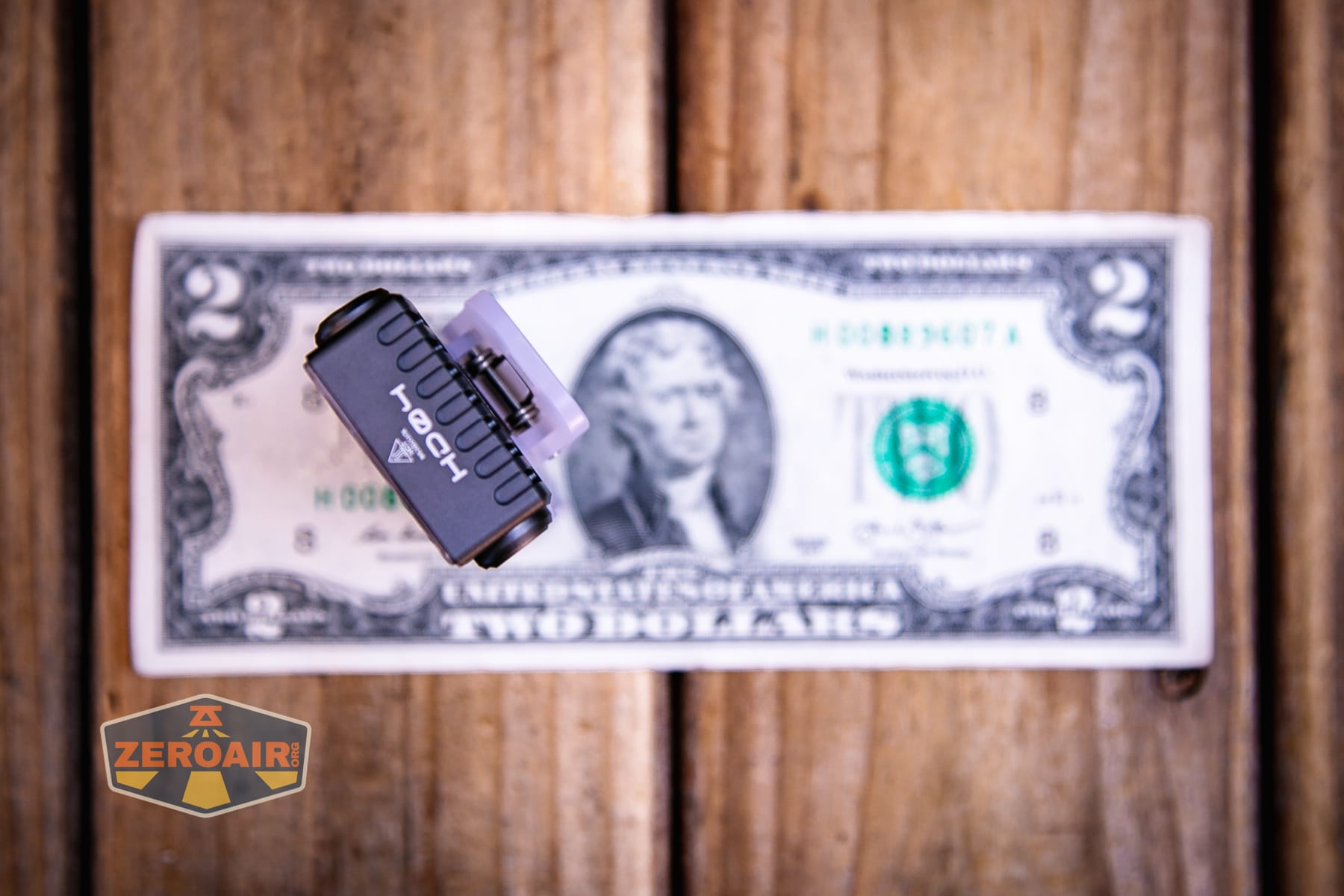 Wurkkos HD04 pocket flashlight on a two dollar bill
