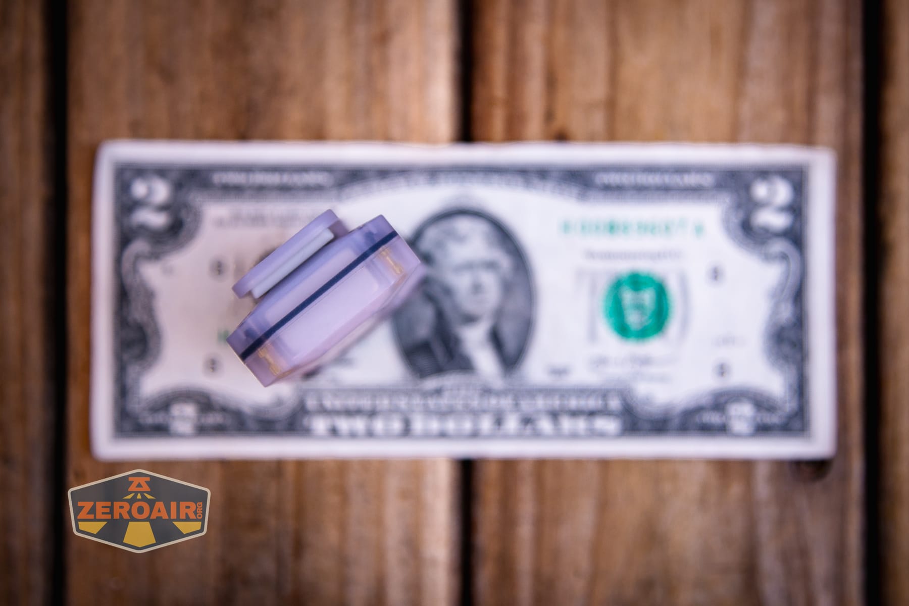 Wurkkos HD04 pocket flashlight on a two dollar bill
