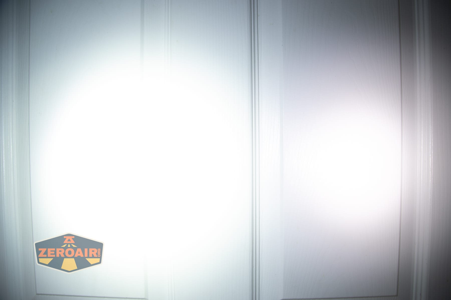 Wurkkos HD04 pocket flashlight beamshots on door (at 1') compared to nichia 219b 4500K