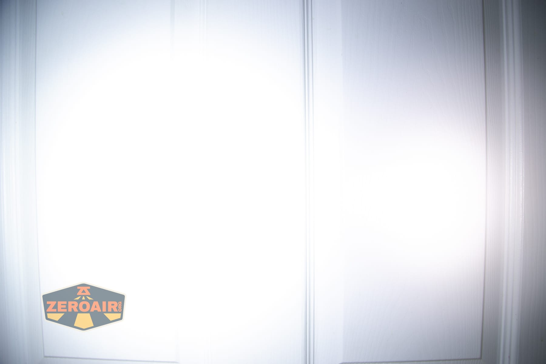 Wurkkos HD04 pocket flashlight beamshots on door (at 1') compared to nichia 219b 4500K
