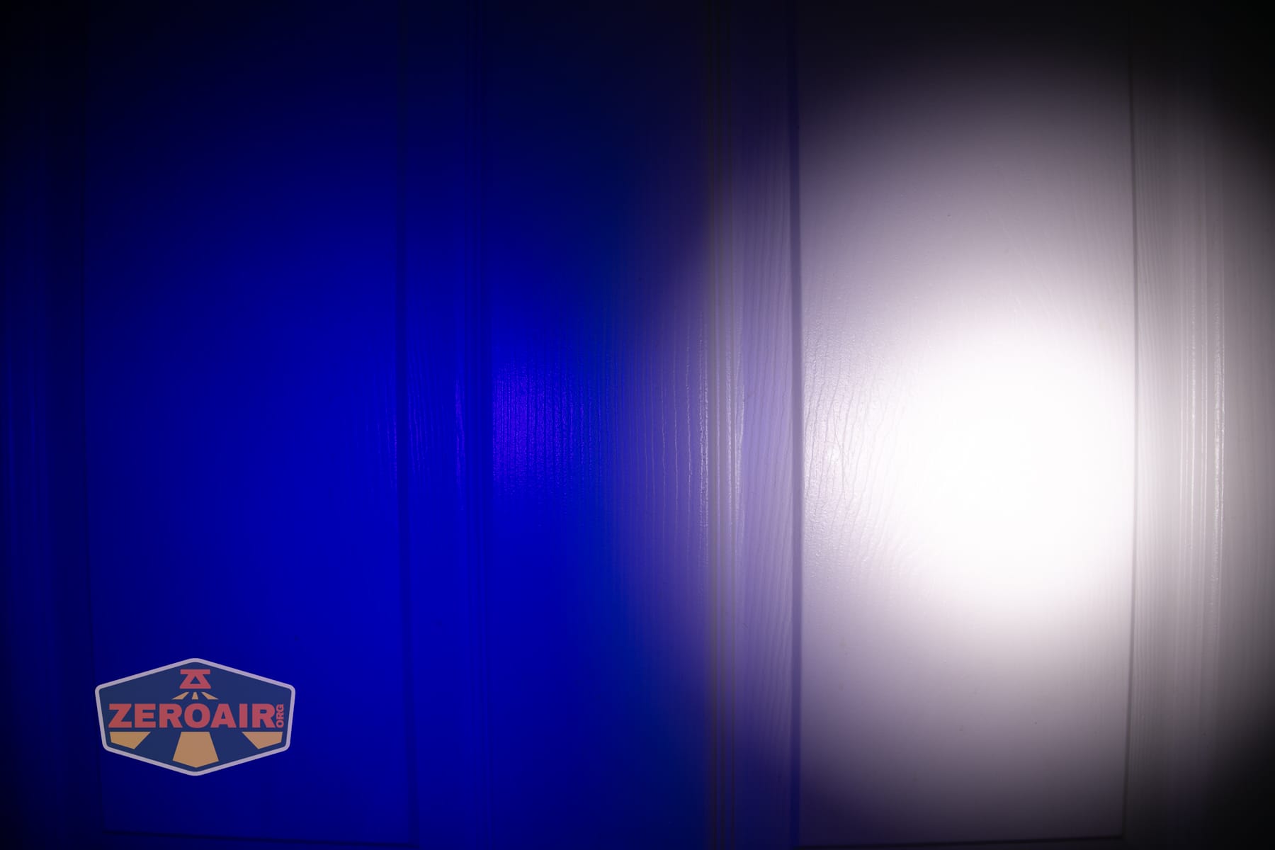 Wurkkos HD04 pocket flashlight beamshots on door (at 1') compared to nichia 219b 4500K