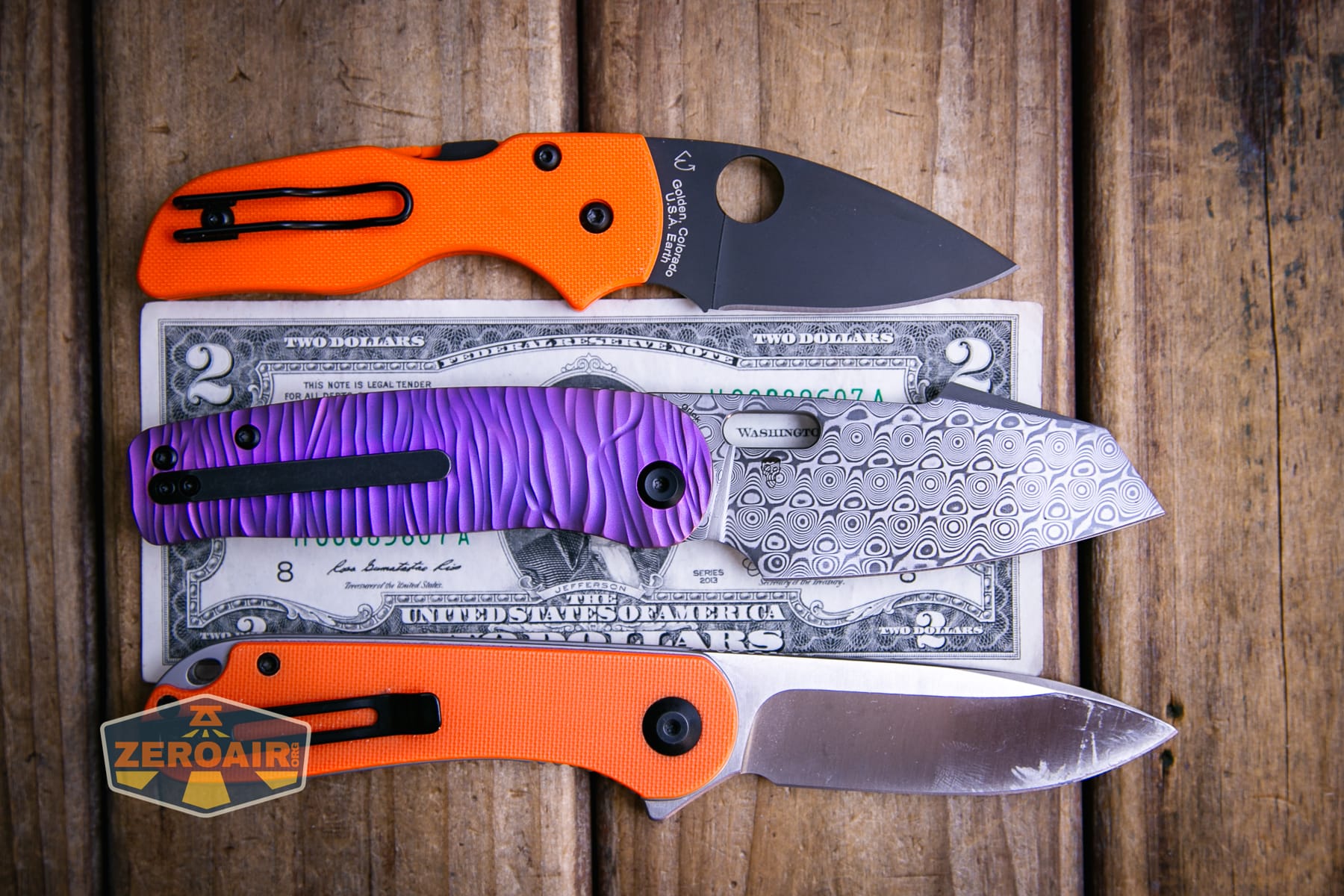Kansept Orlok knife on a two dollar bill compared to Civivi Elementum in orange