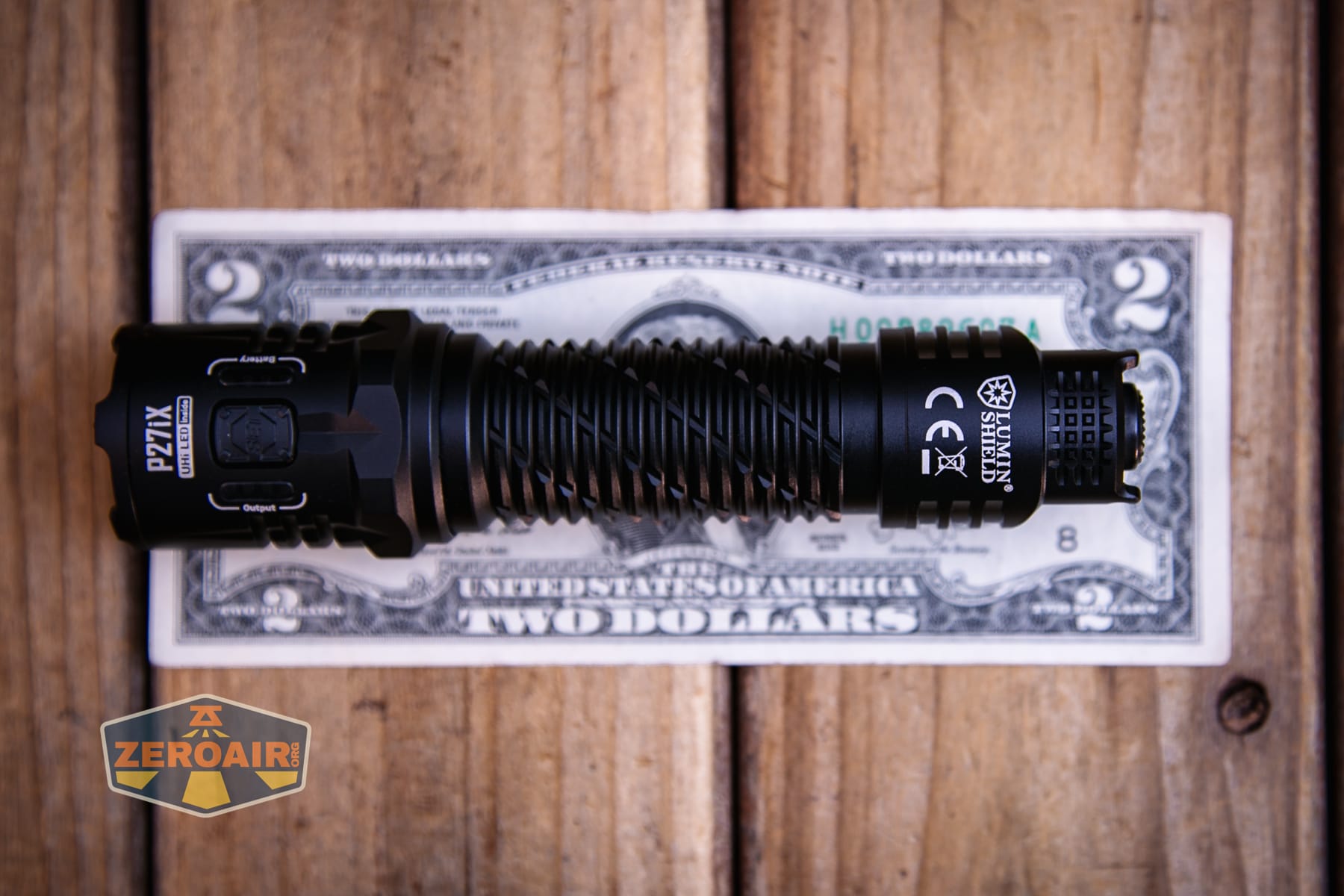 Nitecore P27iX customizable tactical flashlight on a two dollar bill