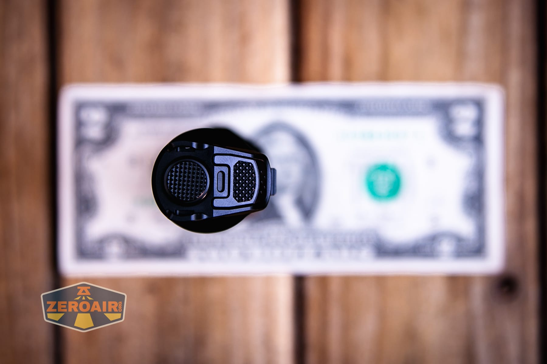 Nitecore P27iX customizable tactical flashlight on a two dollar bill