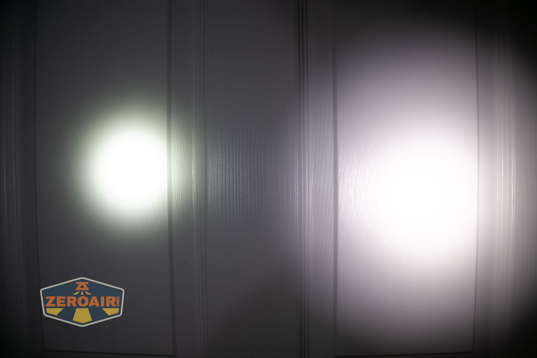 Nitecore P27iX customizable tactical flashlight beamshots on door (at 1') compared to nichia 219b 4500K
