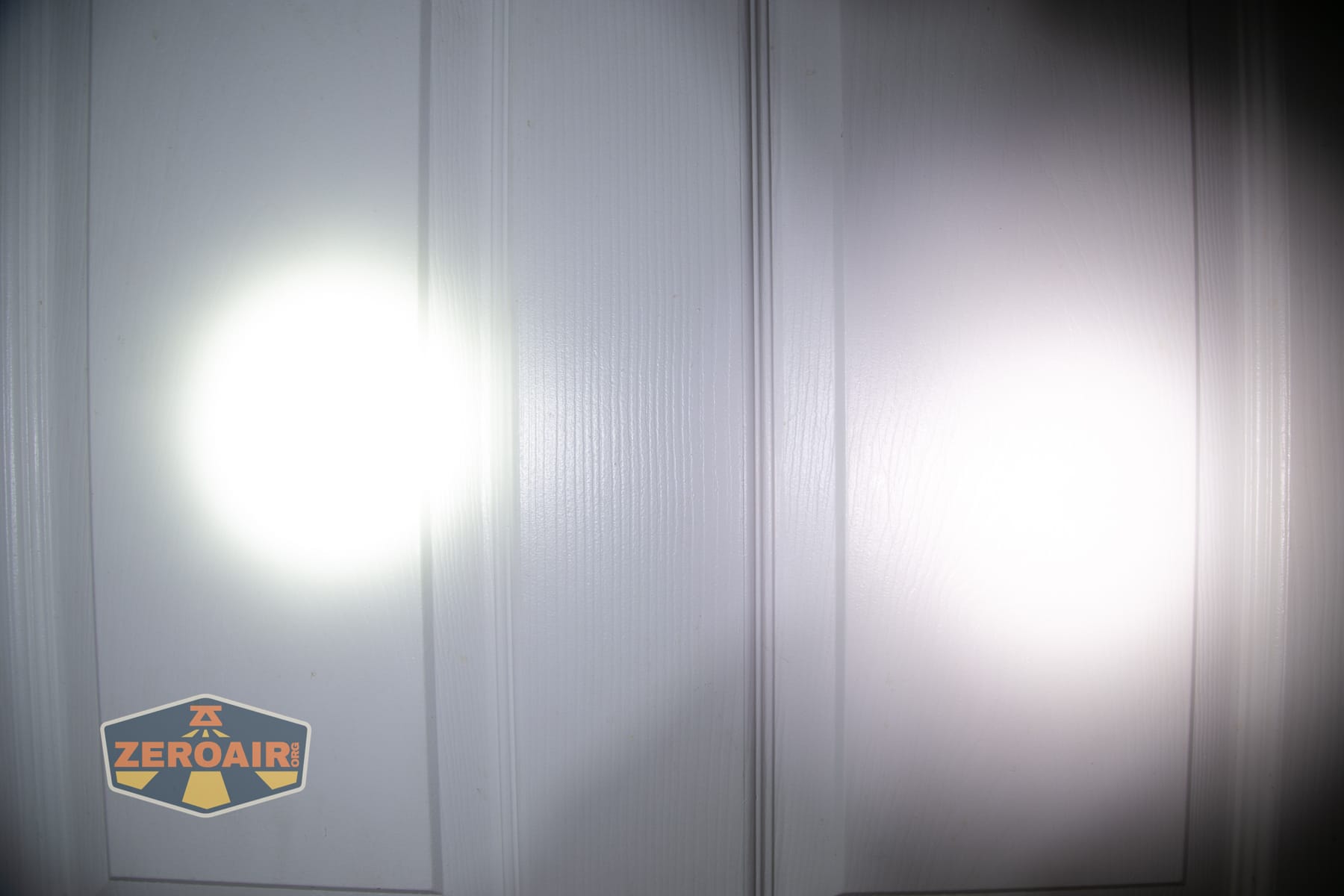 Nitecore P27iX customizable tactical flashlight beamshots on door (at 1') compared to nichia 219b 4500K