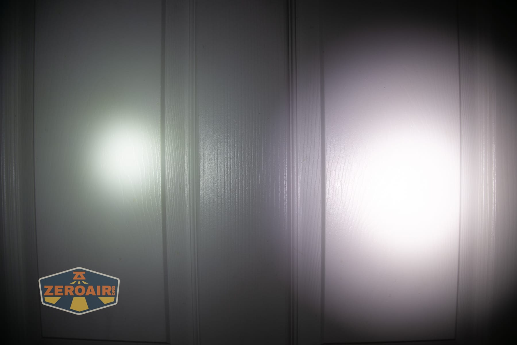 Nitecore P27iX customizable tactical flashlight beamshots on door (at 1') compared to nichia 219b 4500K