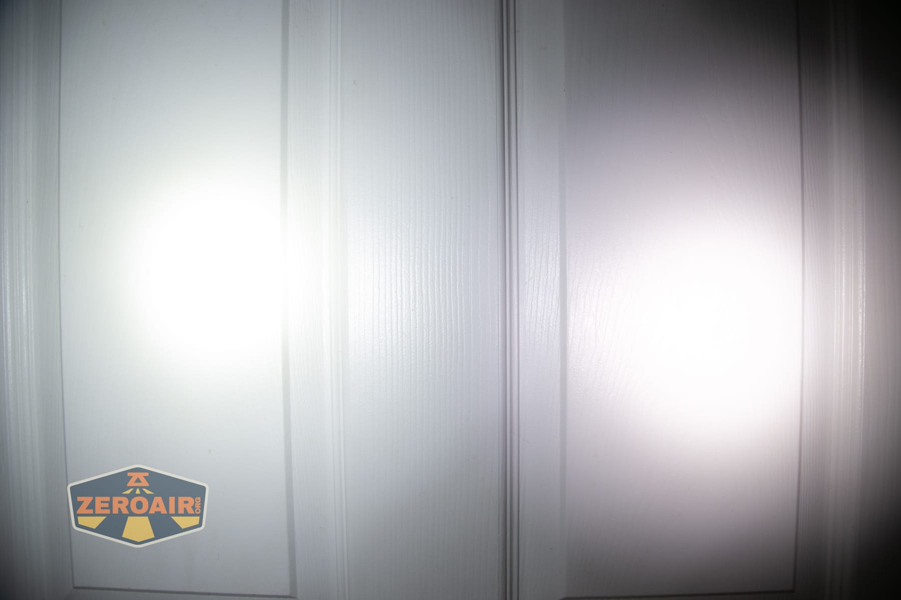 Nitecore P27iX customizable tactical flashlight beamshots on door (at 1') compared to nichia 219b 4500K
