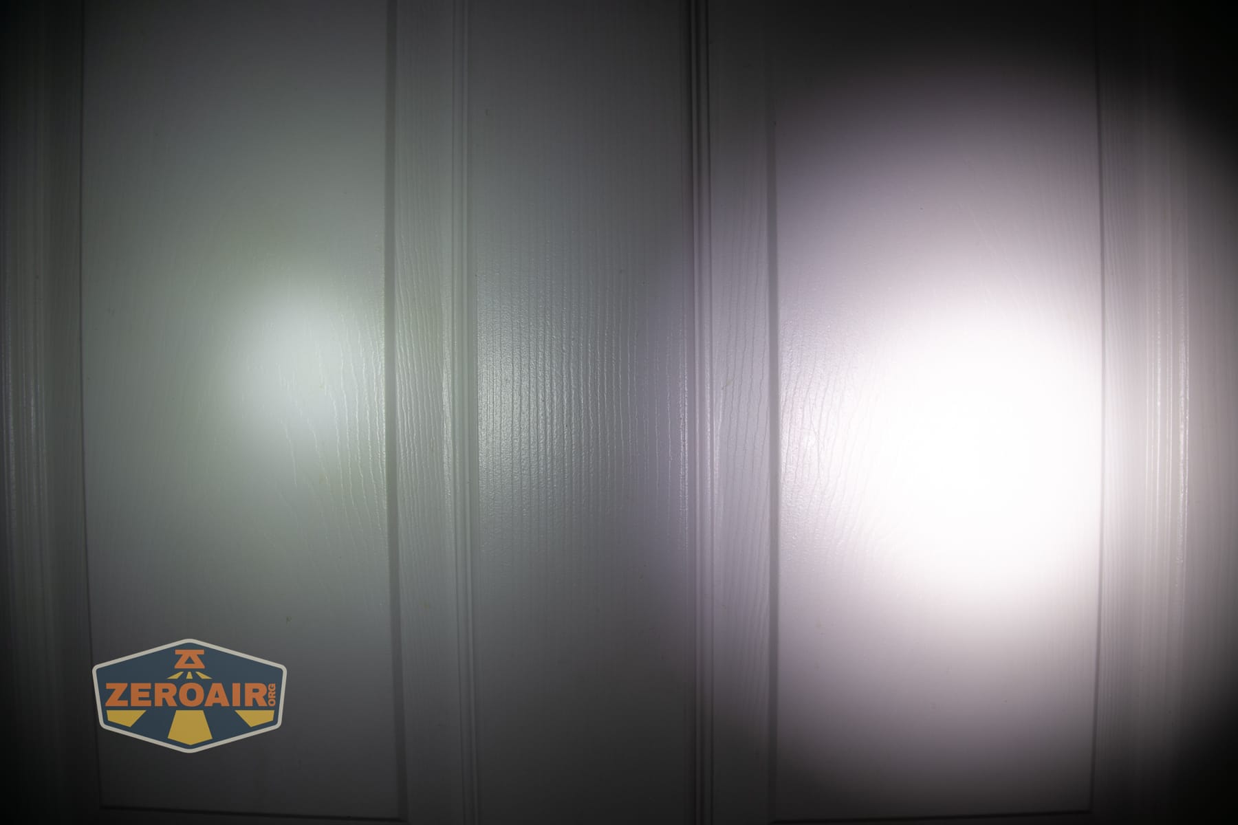 Nitecore P27iX customizable tactical flashlight beamshots on door (at 1') compared to nichia 219b 4500K