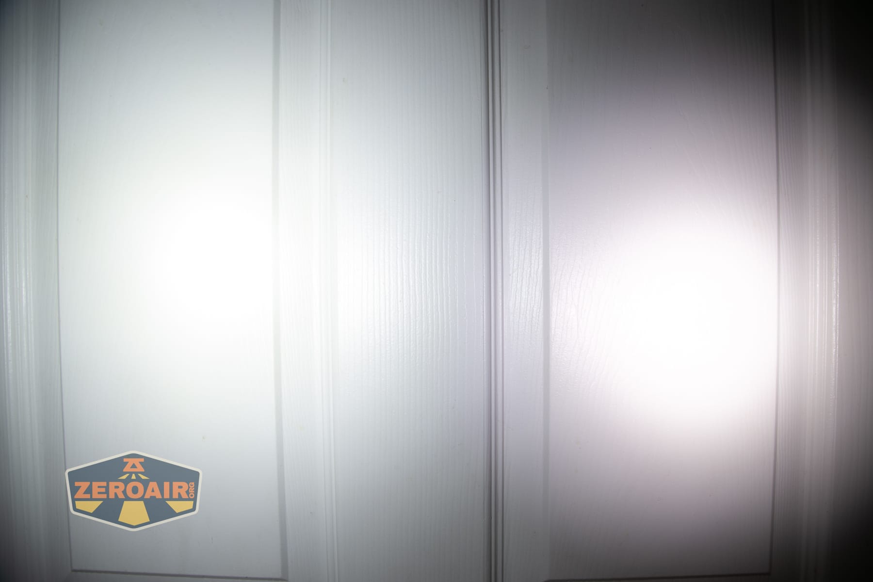Nitecore P27iX customizable tactical flashlight beamshots on door (at 1') compared to nichia 219b 4500K