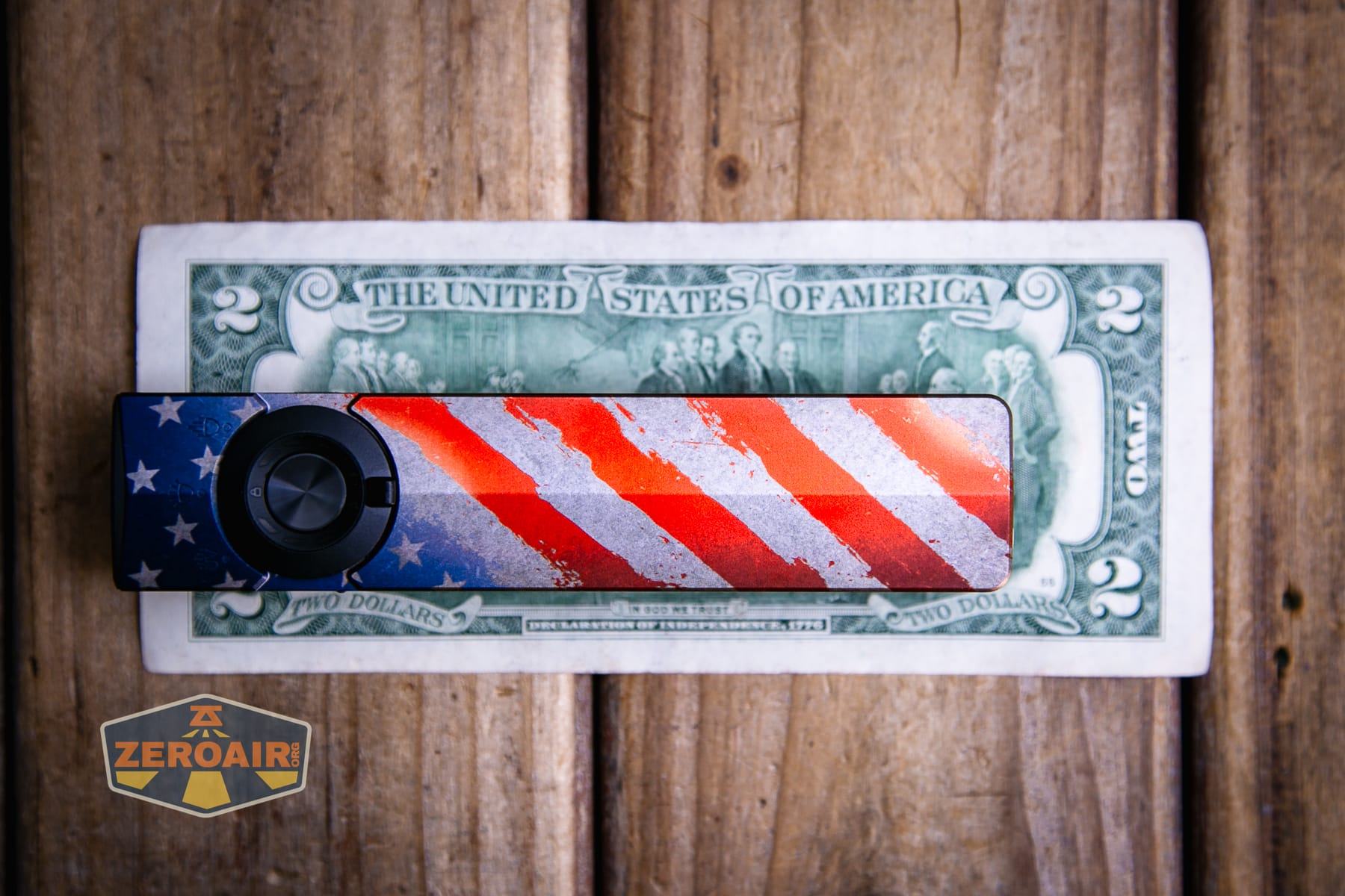 Olight Arkpro Stars and Stripes flat flashlight on a two dollar bill