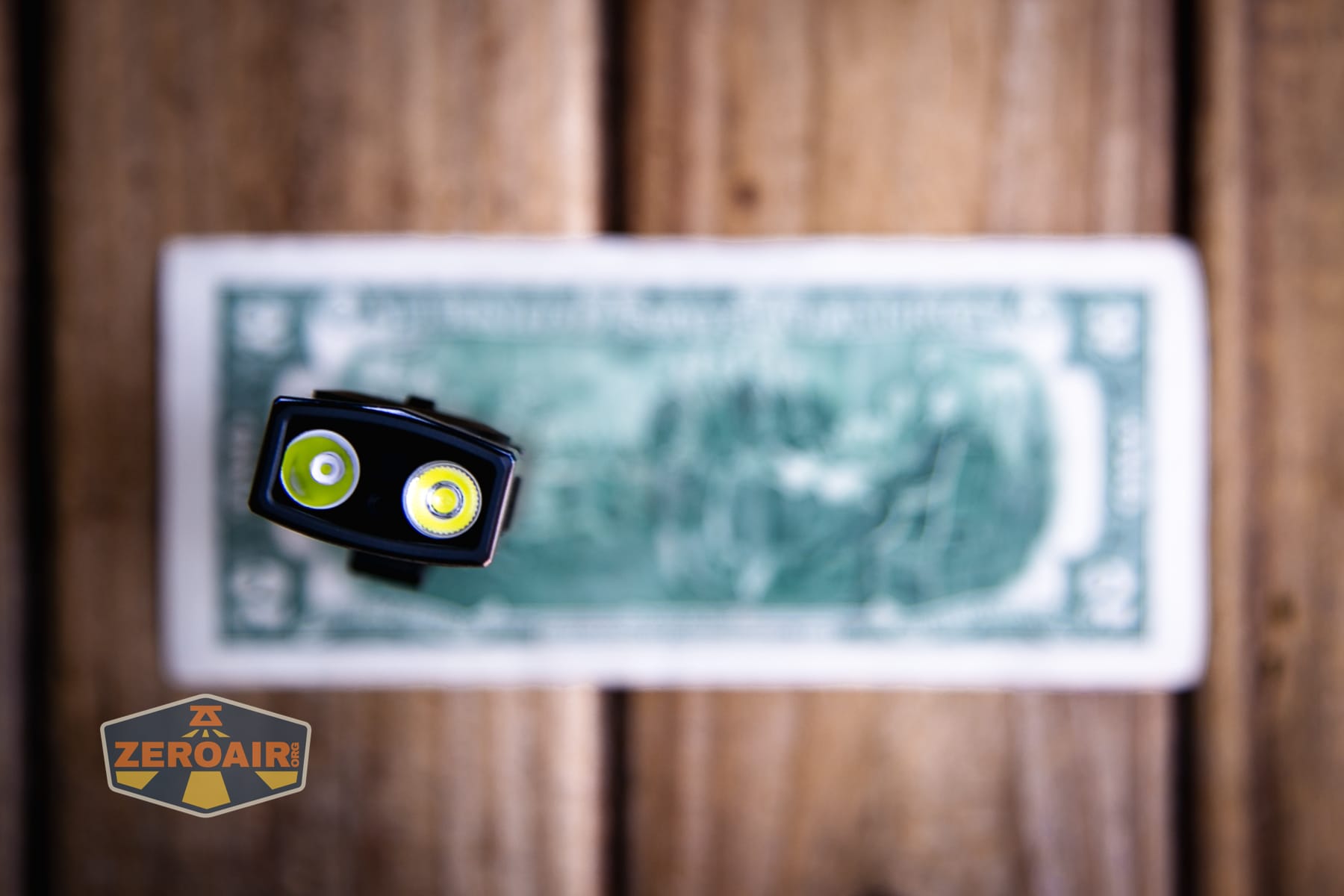 Olight Arkpro Stars and Stripes flat flashlight on a two dollar bill