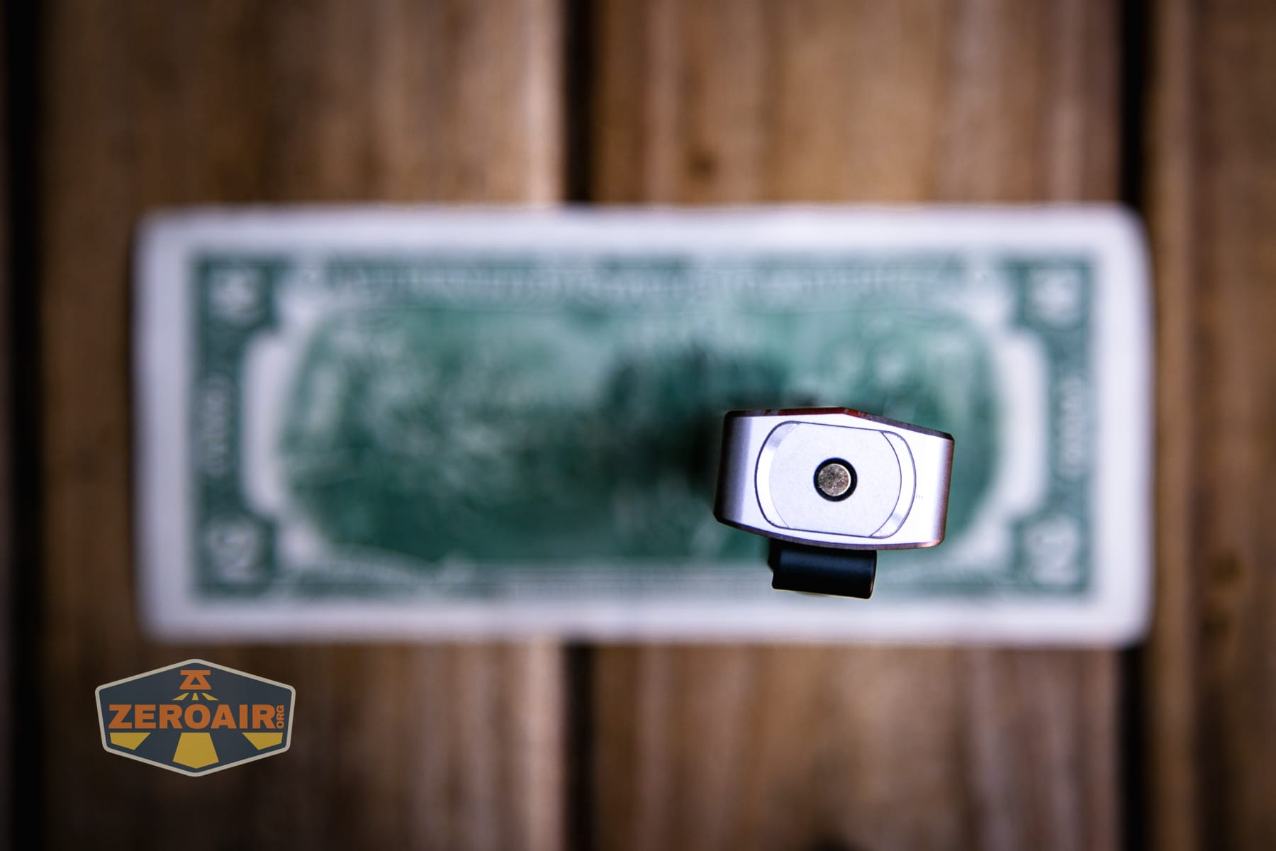 Olight Arkpro Stars and Stripes flat flashlight on a two dollar bill