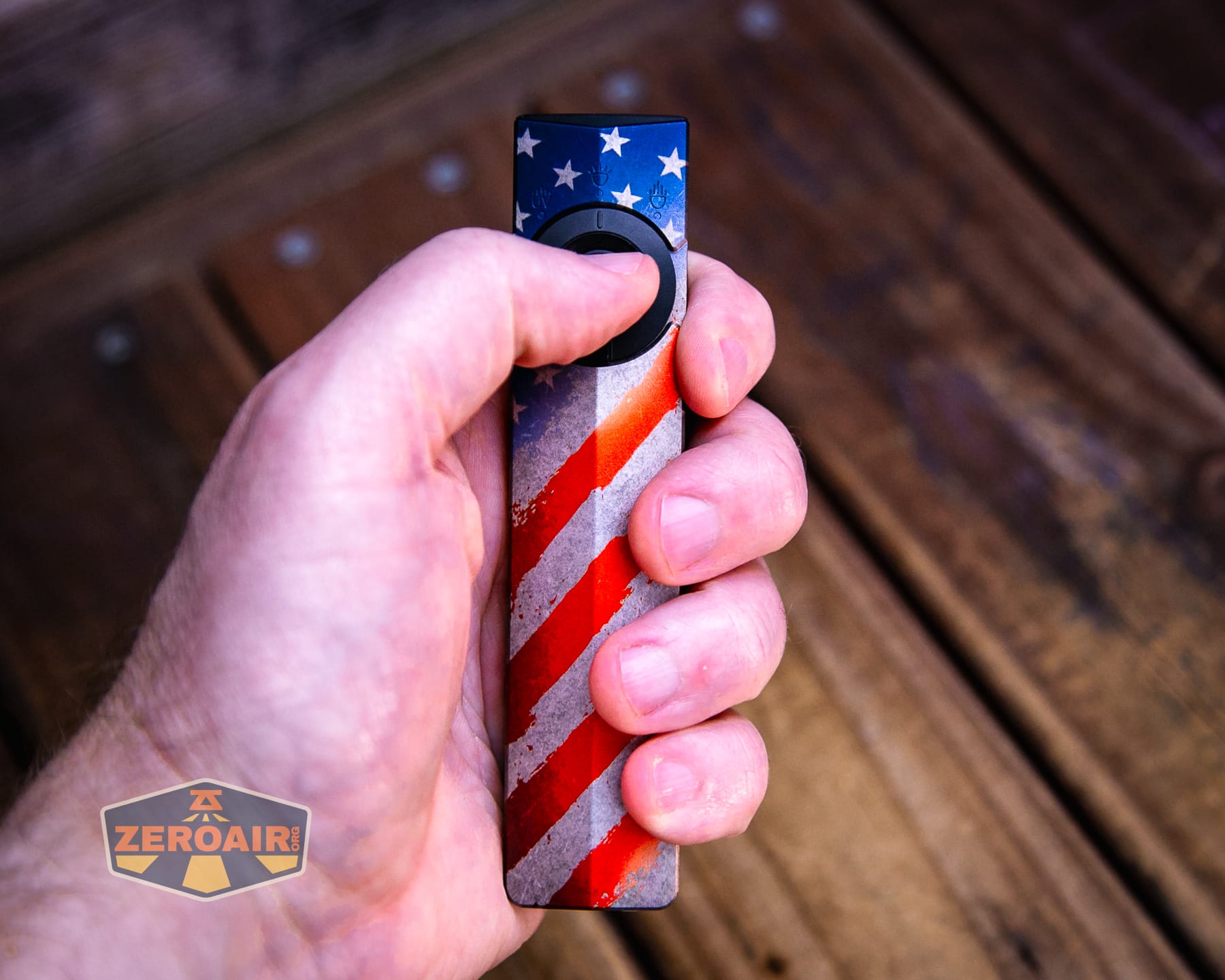 Olight Arkpro Stars and Stripes flat flashlight in hand