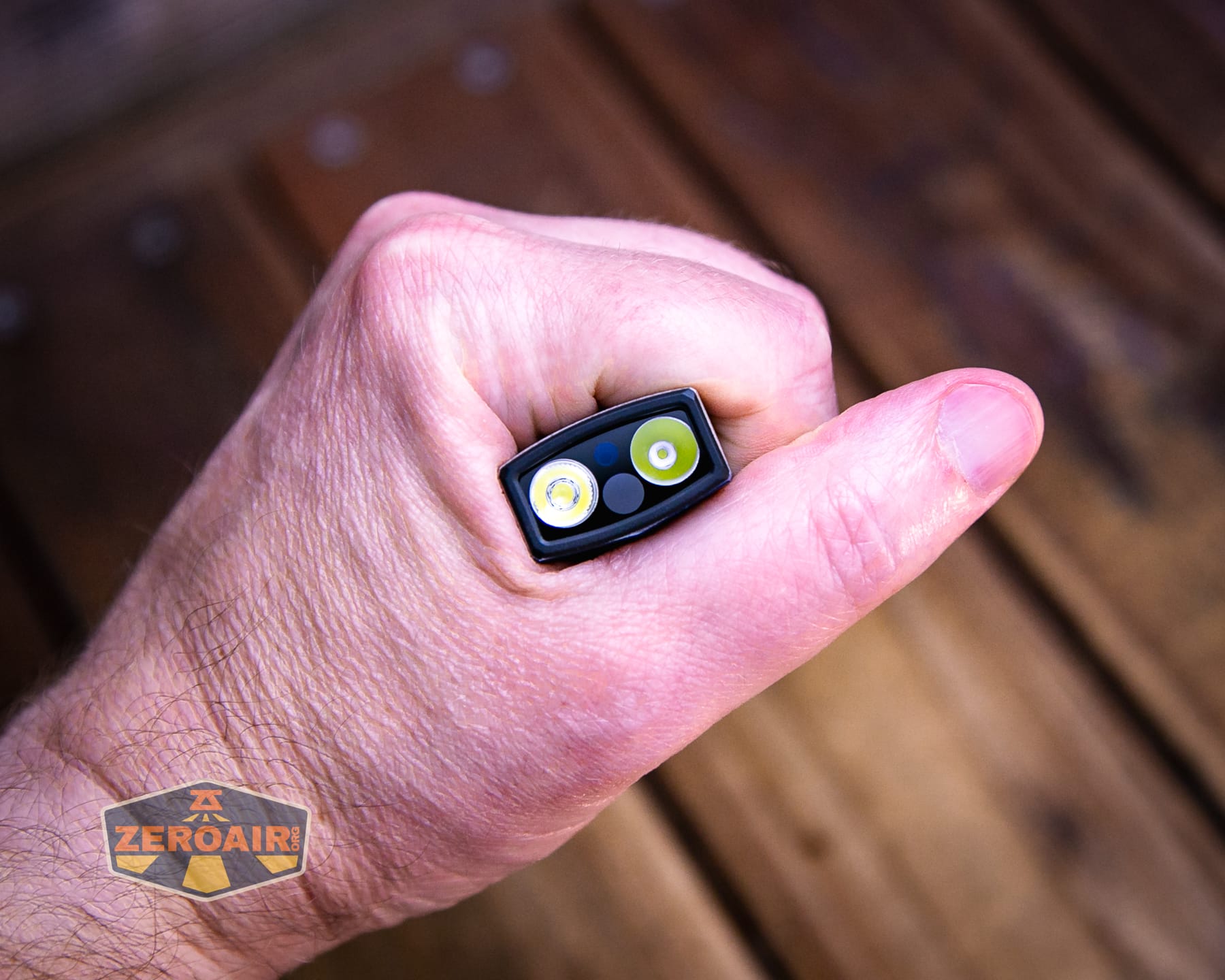 Olight Arkpro Stars and Stripes flat flashlight in hand