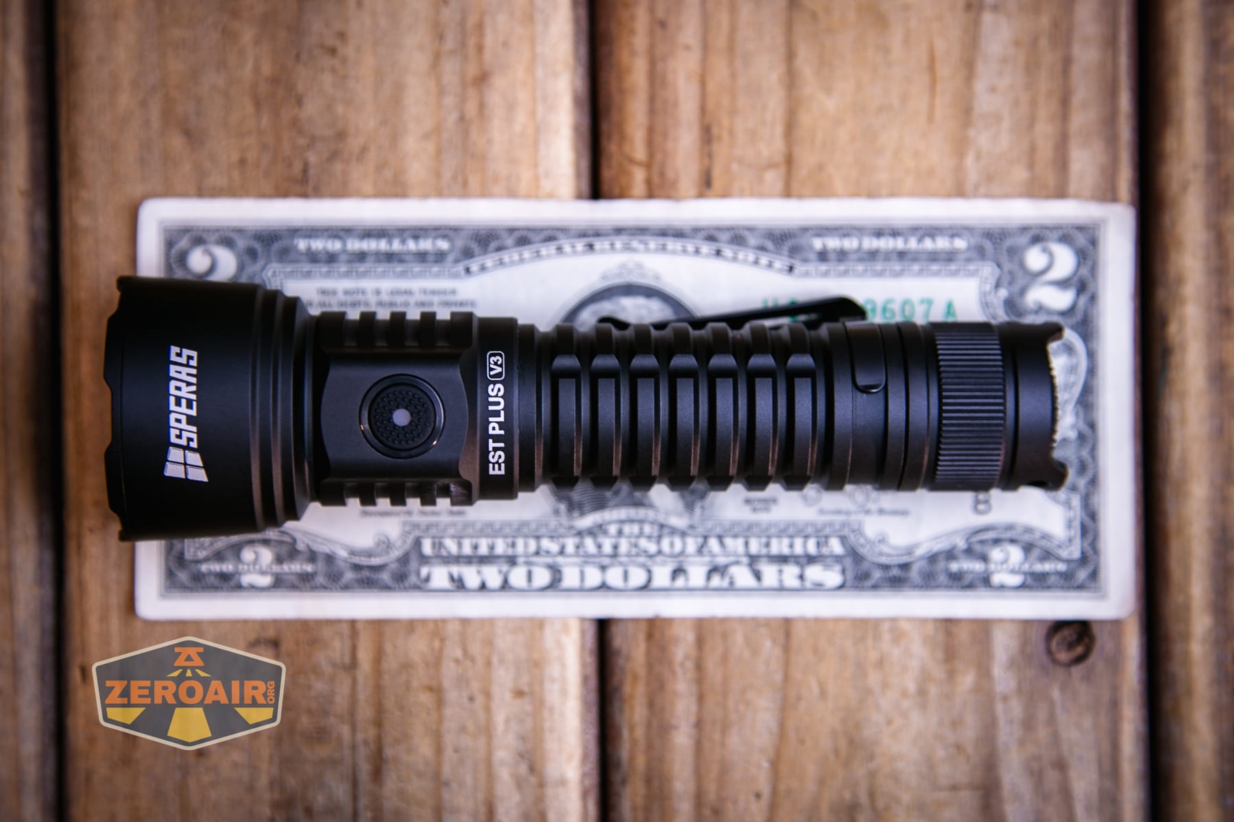 Speras EST PLUS V3 flashlight on a two dollar bill