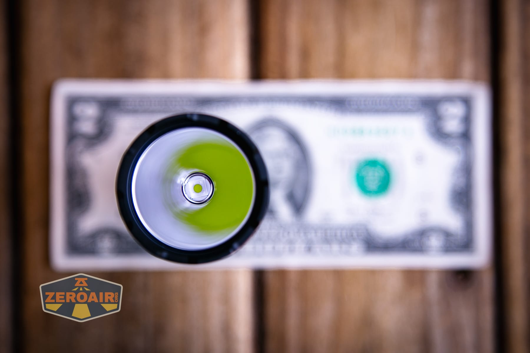Speras EST PLUS V3 flashlight on a two dollar bill