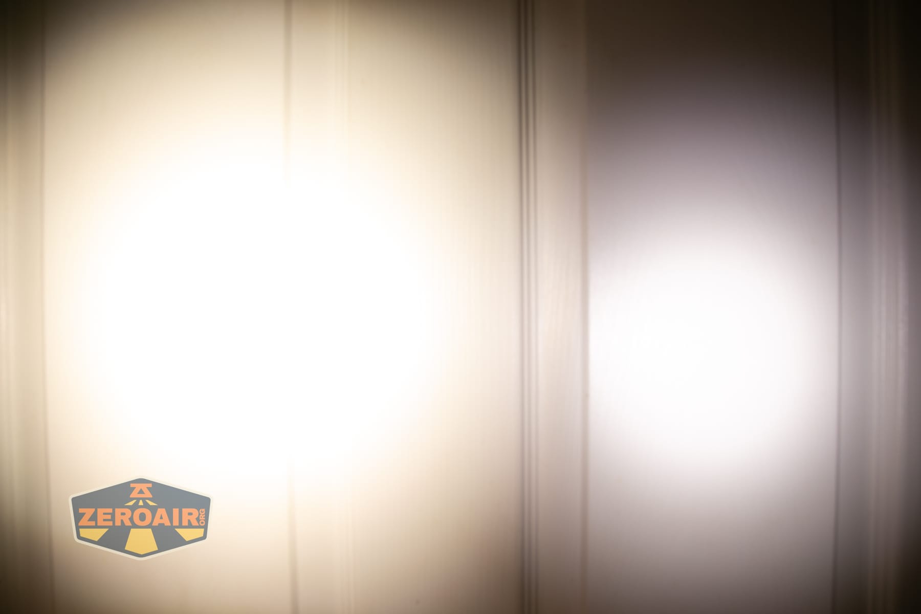Vezerlezer WK2 flat flashlight beamshots on door (at 1') compared to nichia 219b 4500K