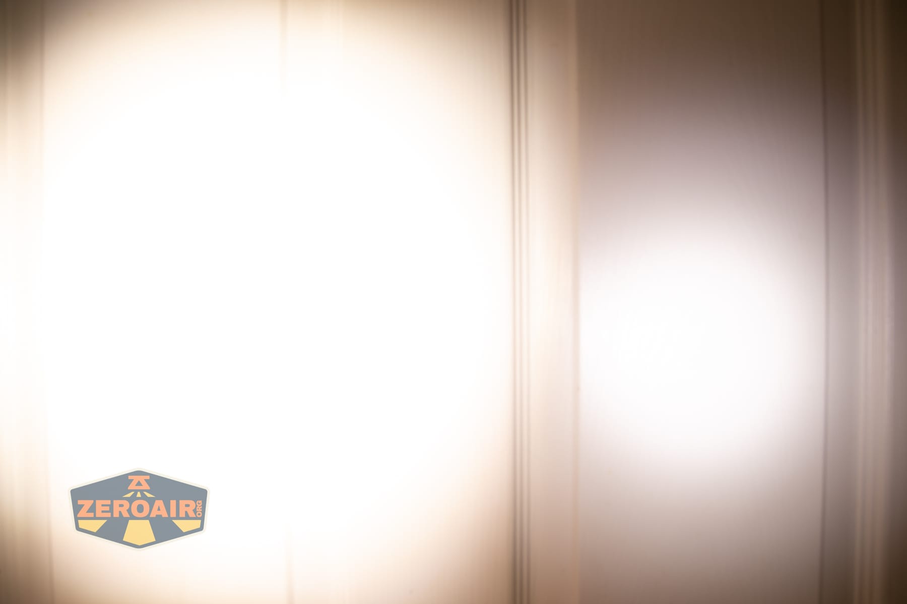Vezerlezer WK2 flat flashlight beamshots on door (at 1') compared to nichia 219b 4500K