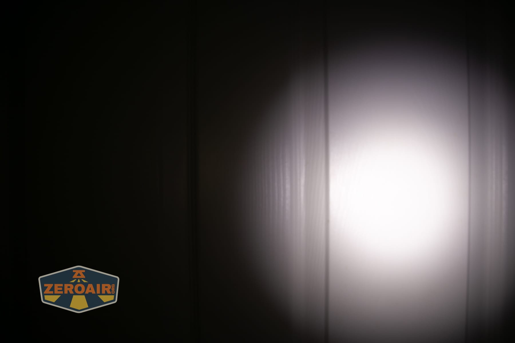 Vezerlezer WK2 flat flashlight beamshots on door (at 1') compared to nichia 219b 4500K