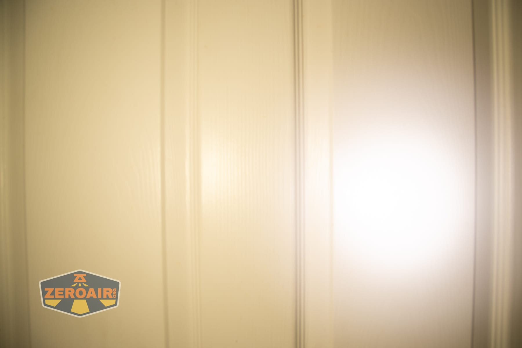 Vezerlezer WK2 flat flashlight beamshots on door (at 1') compared to nichia 219b 4500K