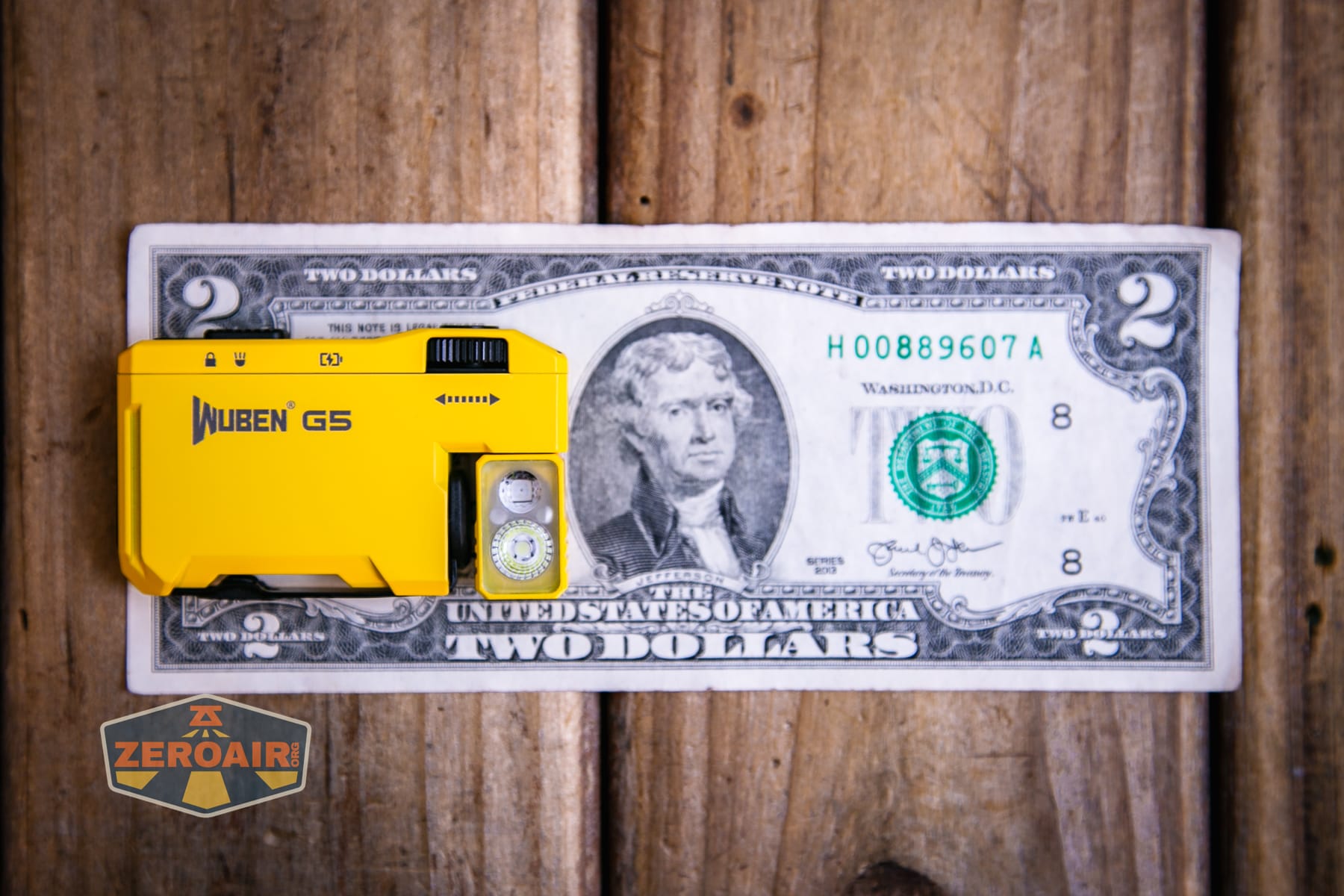 Wuben G5 Yellow EDC Keychain flashlight on a two dollar bill