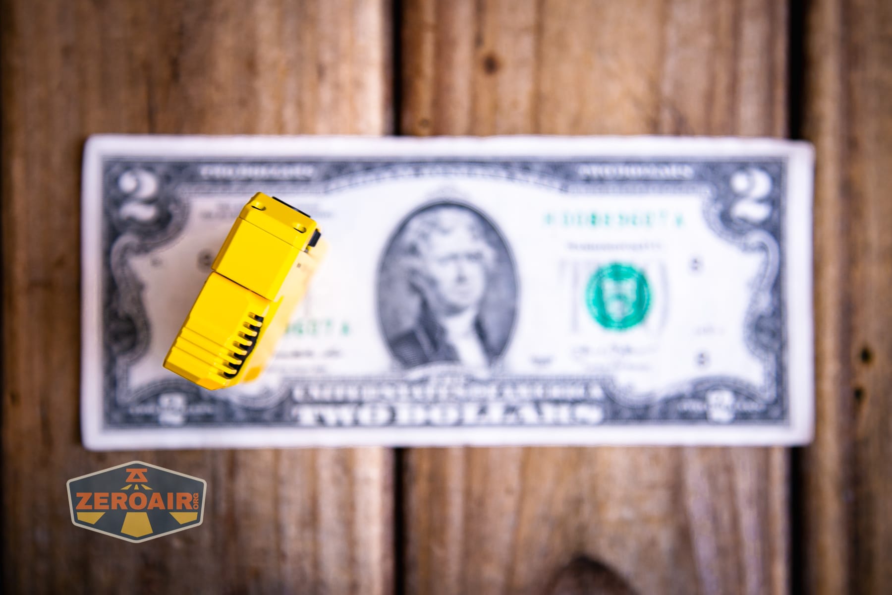 Wuben G5 Yellow EDC Keychain flashlight on a two dollar bill
