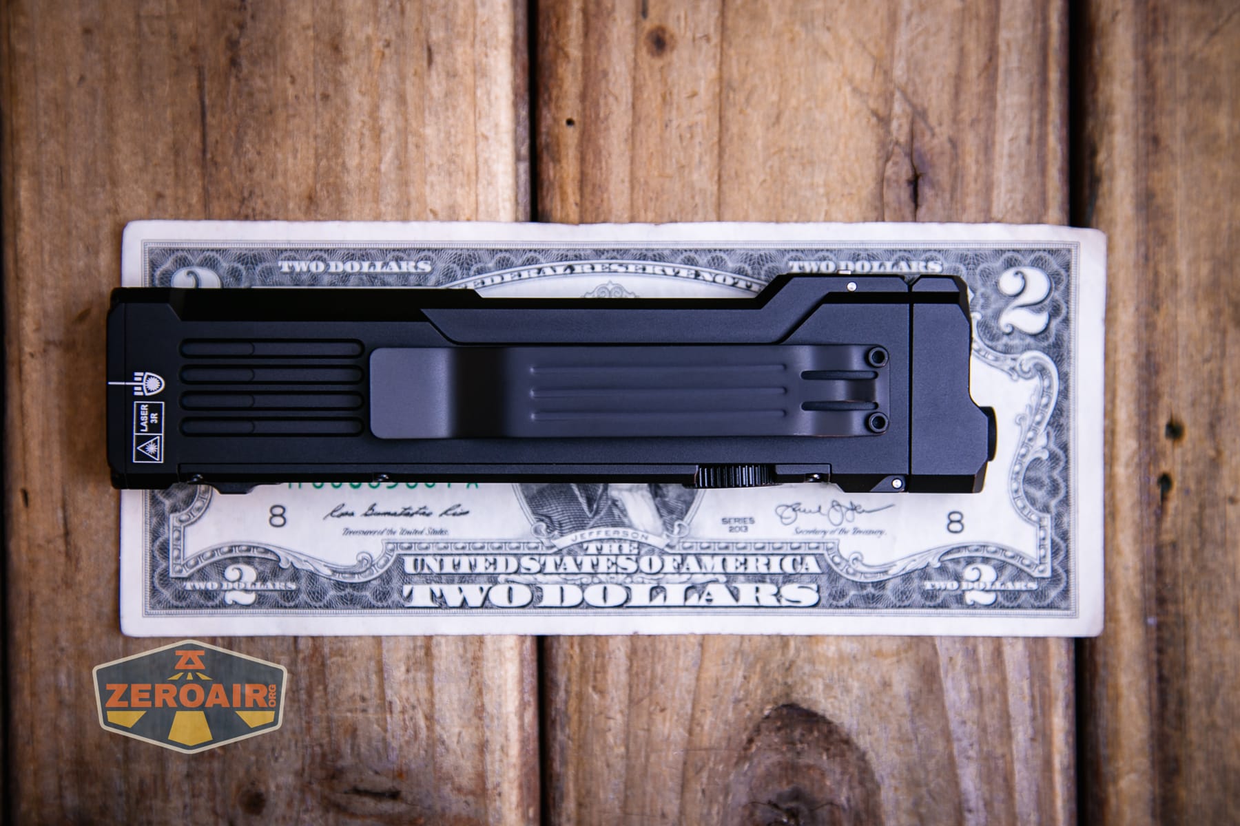 Wuben X5 3-in-1 compact EDC flashlight on a two dollar bill
