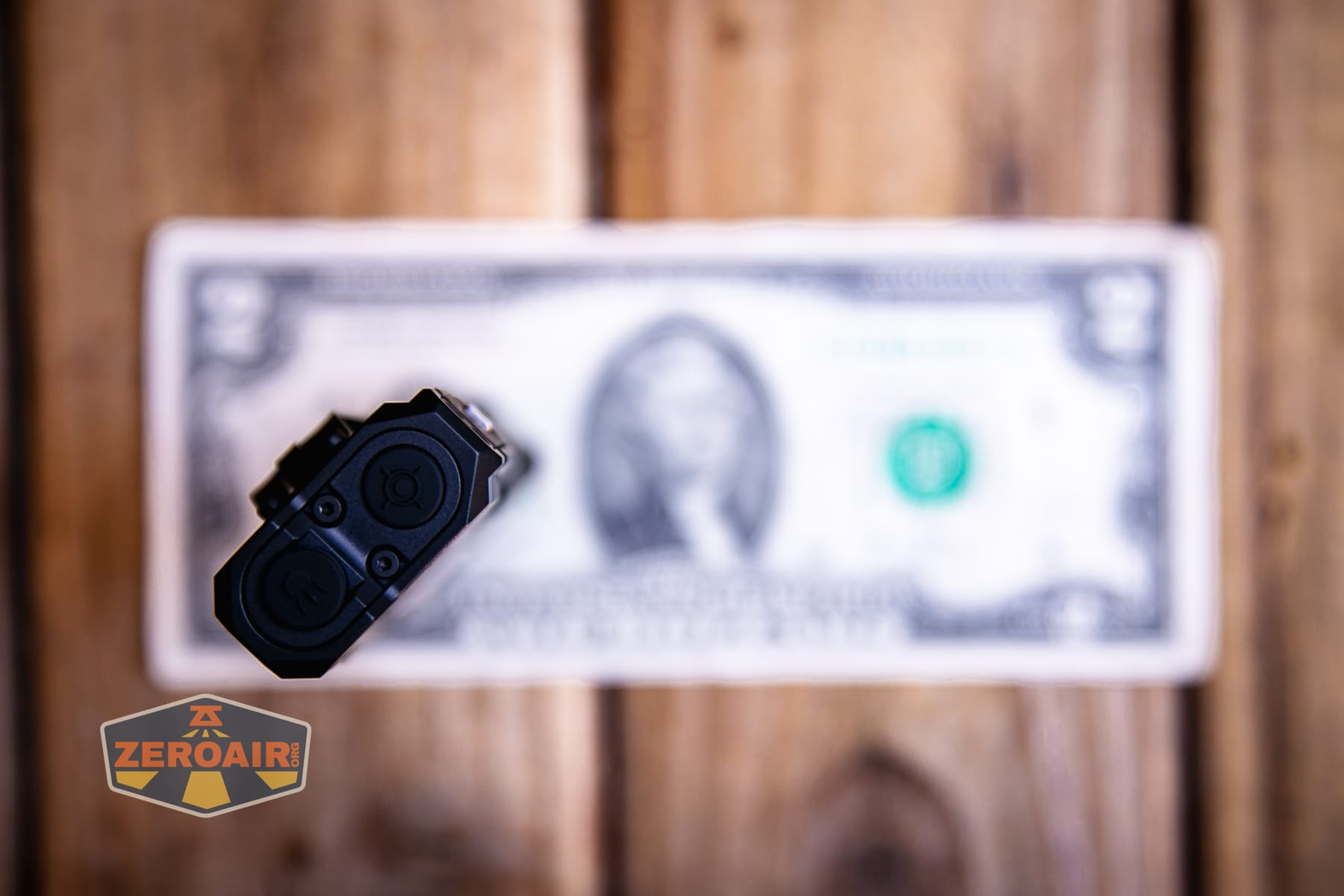 Wuben X5 3-in-1 compact EDC flashlight on a two dollar bill