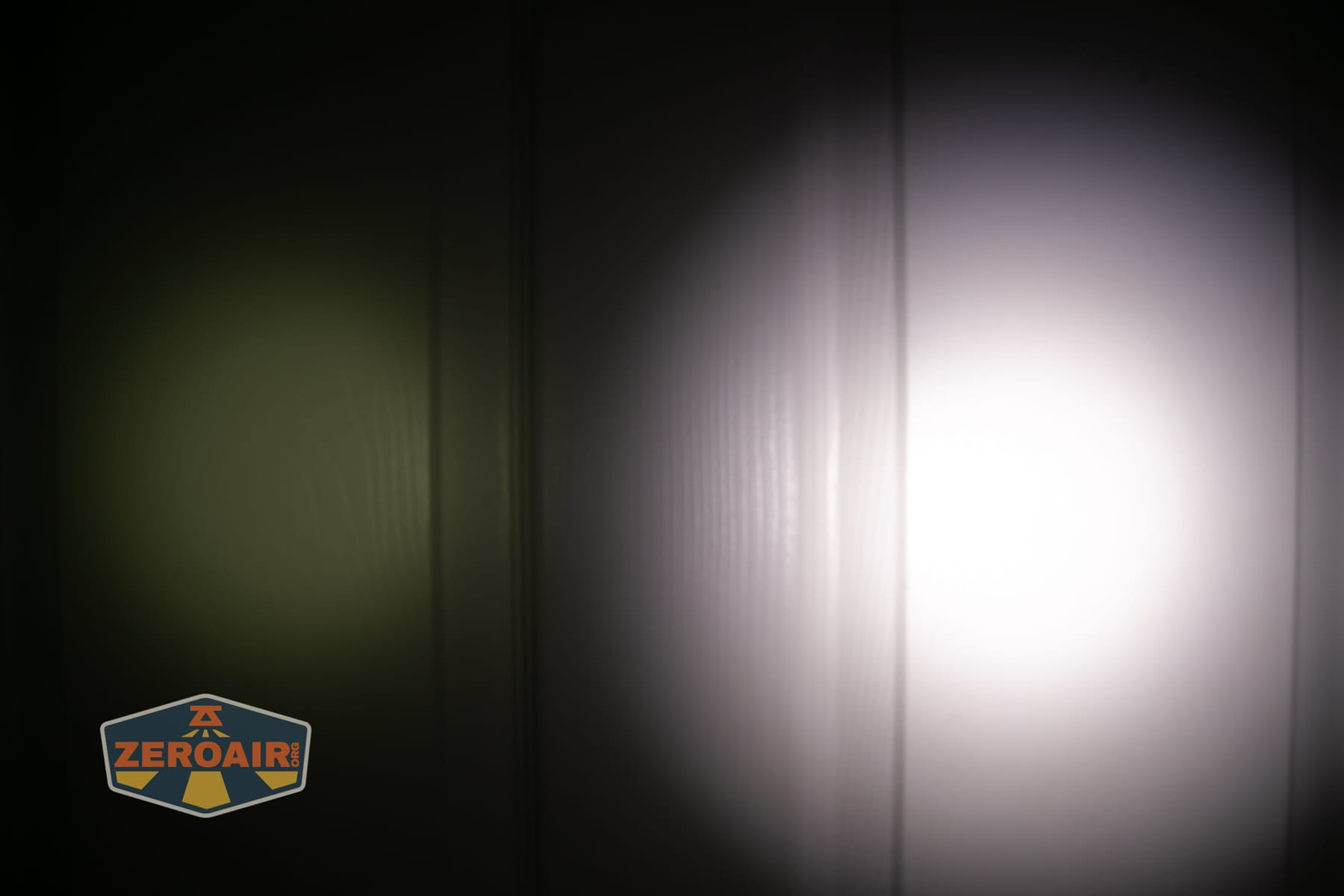 Wuben X5 3-in-1 compact EDC flashlight beamshots on door (at 1') compared to nichia 219b 4500K