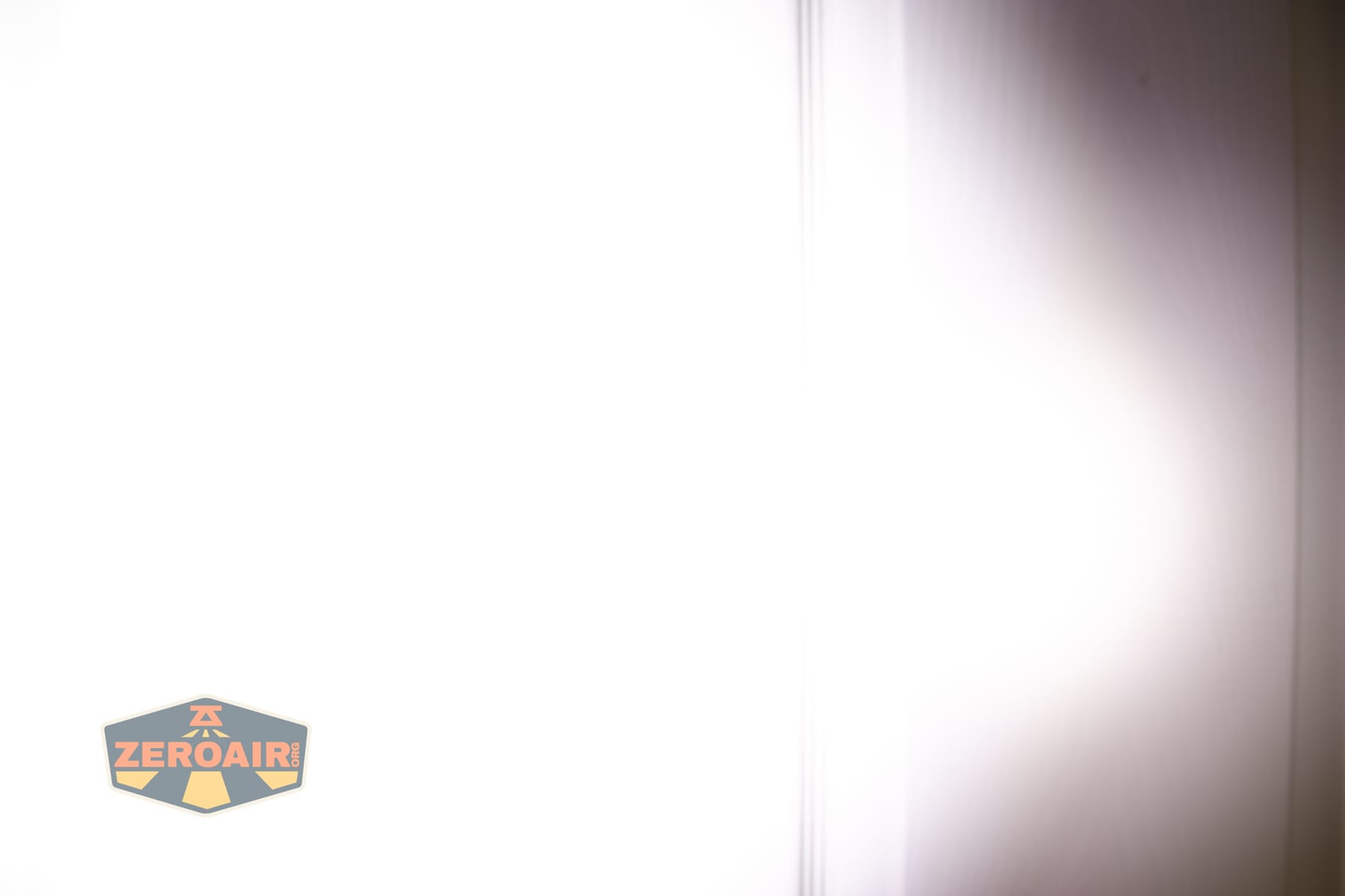 Wuben X5 3-in-1 compact EDC flashlight beamshots on door (at 1') compared to nichia 219b 4500K