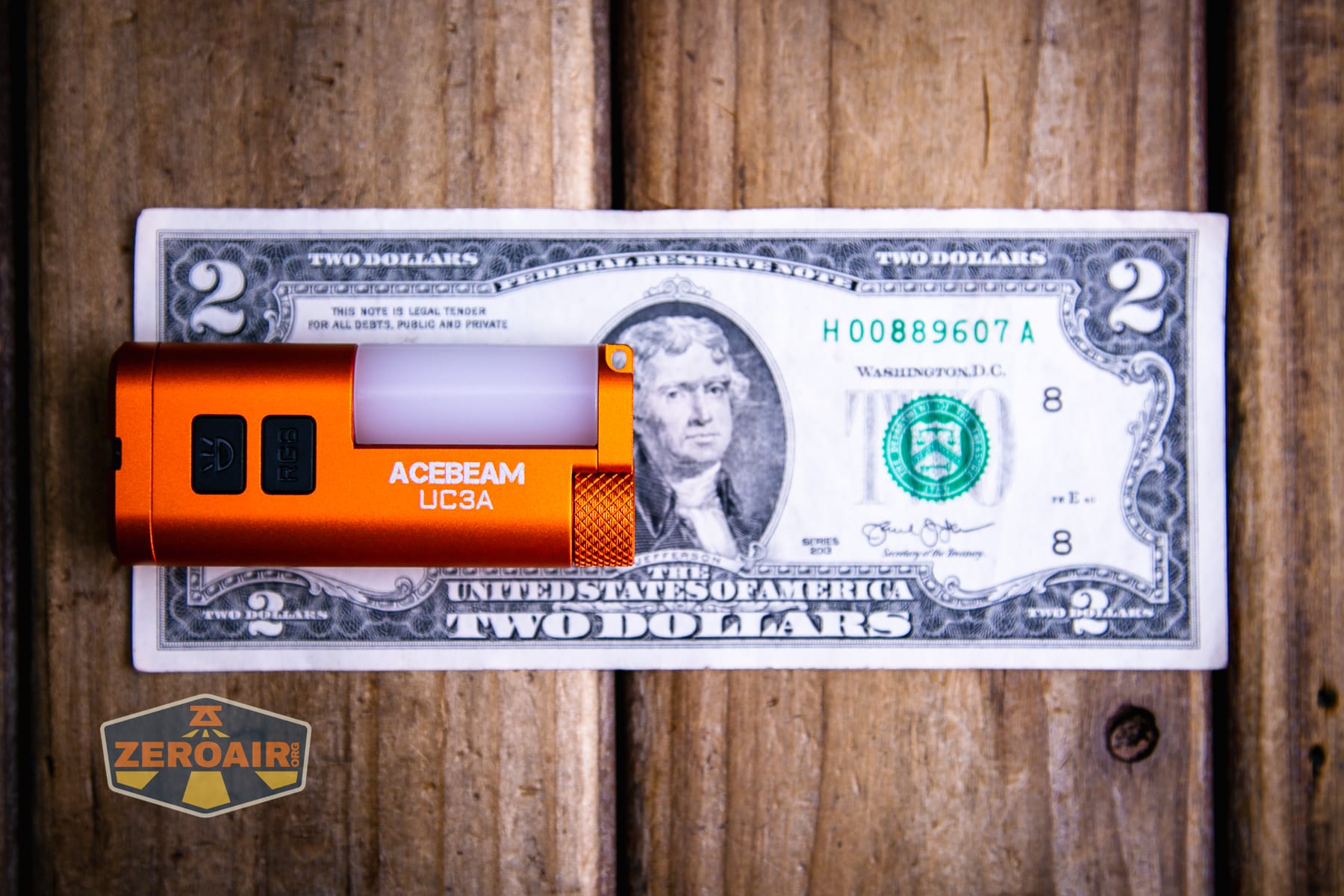 Acebeam UC3A Signal flashlight on a two dollar bill