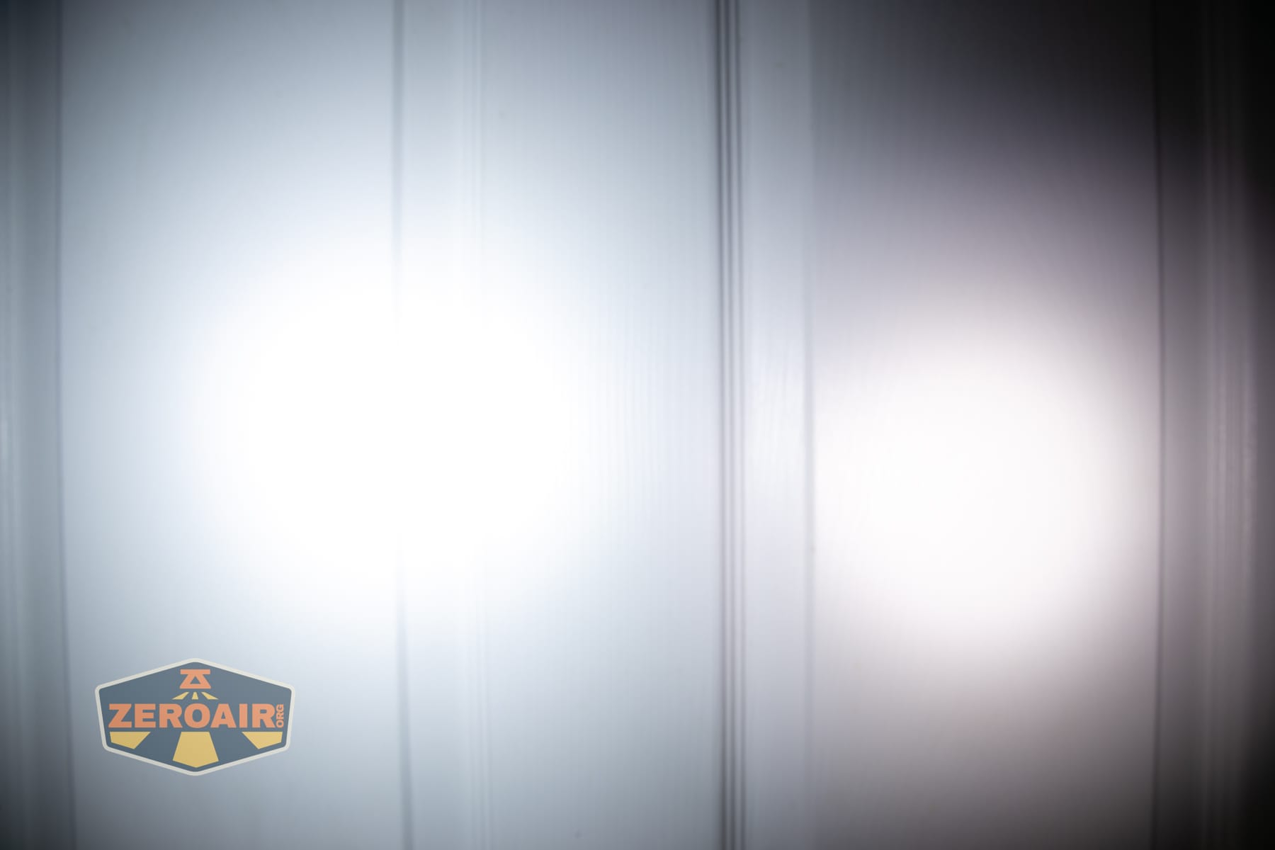 Acebeam UC3A Signal flashlight beamshots on door (at 1') compared to nichia 219b 4500K